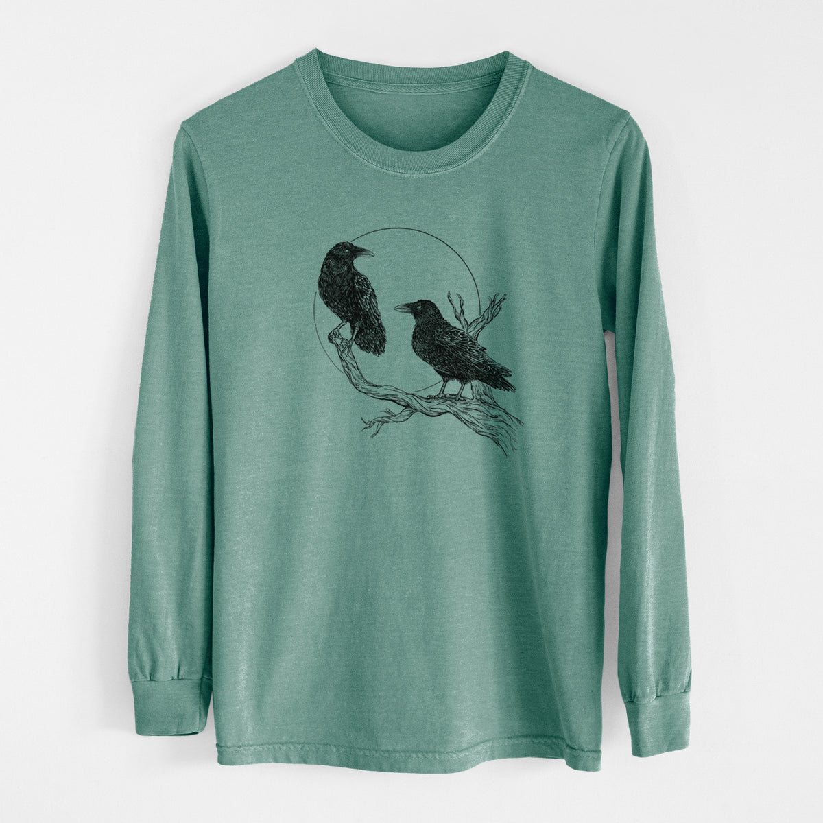 Pine green Comfort Colors long sleeve shirt laid flat, printed with a black ink illustration of two ravens perched on a branch in front of a full moon.