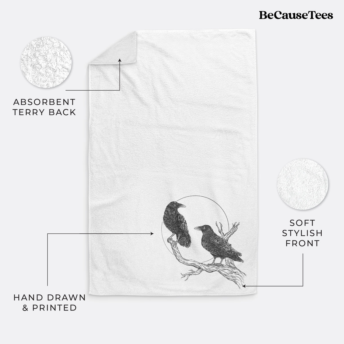 White hand towel printed with a black ink illustration of two ravens perched on a branch in front of a full moon.