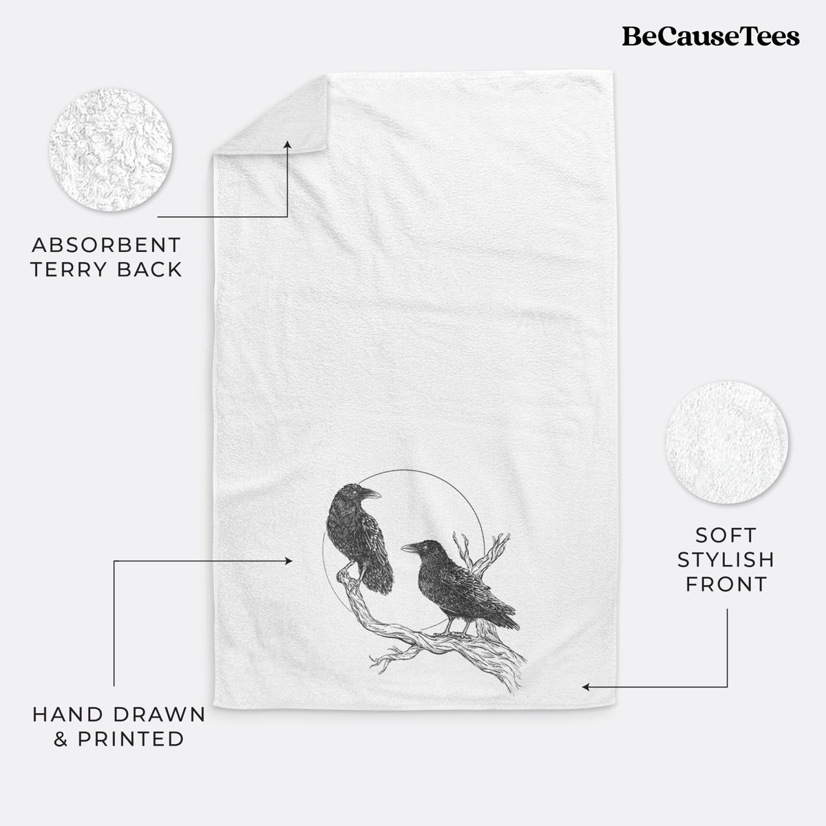 White hand towel printed with a black ink illustration of two ravens perched on a branch in front of a full moon.