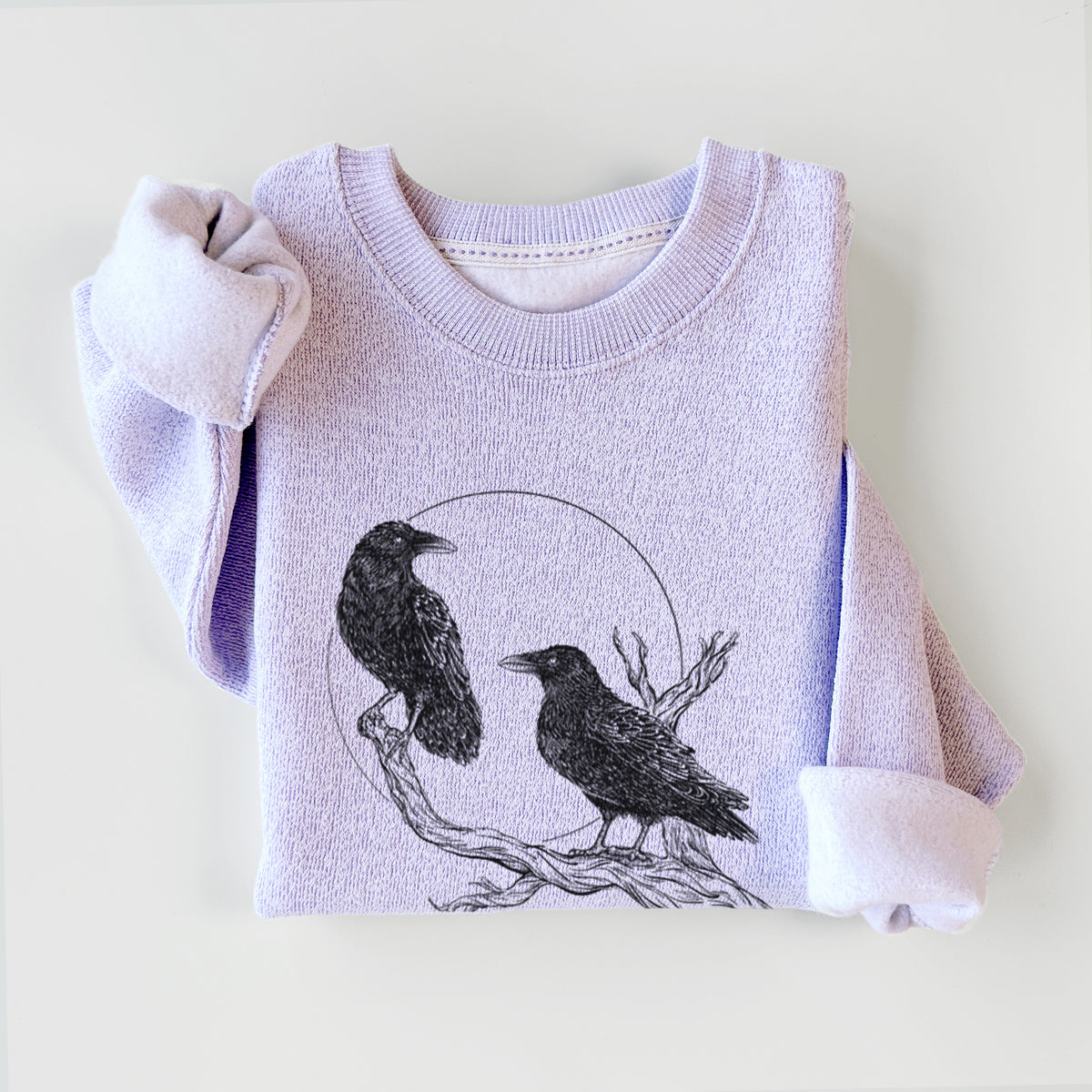 Ice purple knit sweatshirt printed with a black ink illustration of two ravens perched on a branch in front of a full moon, styled flat.