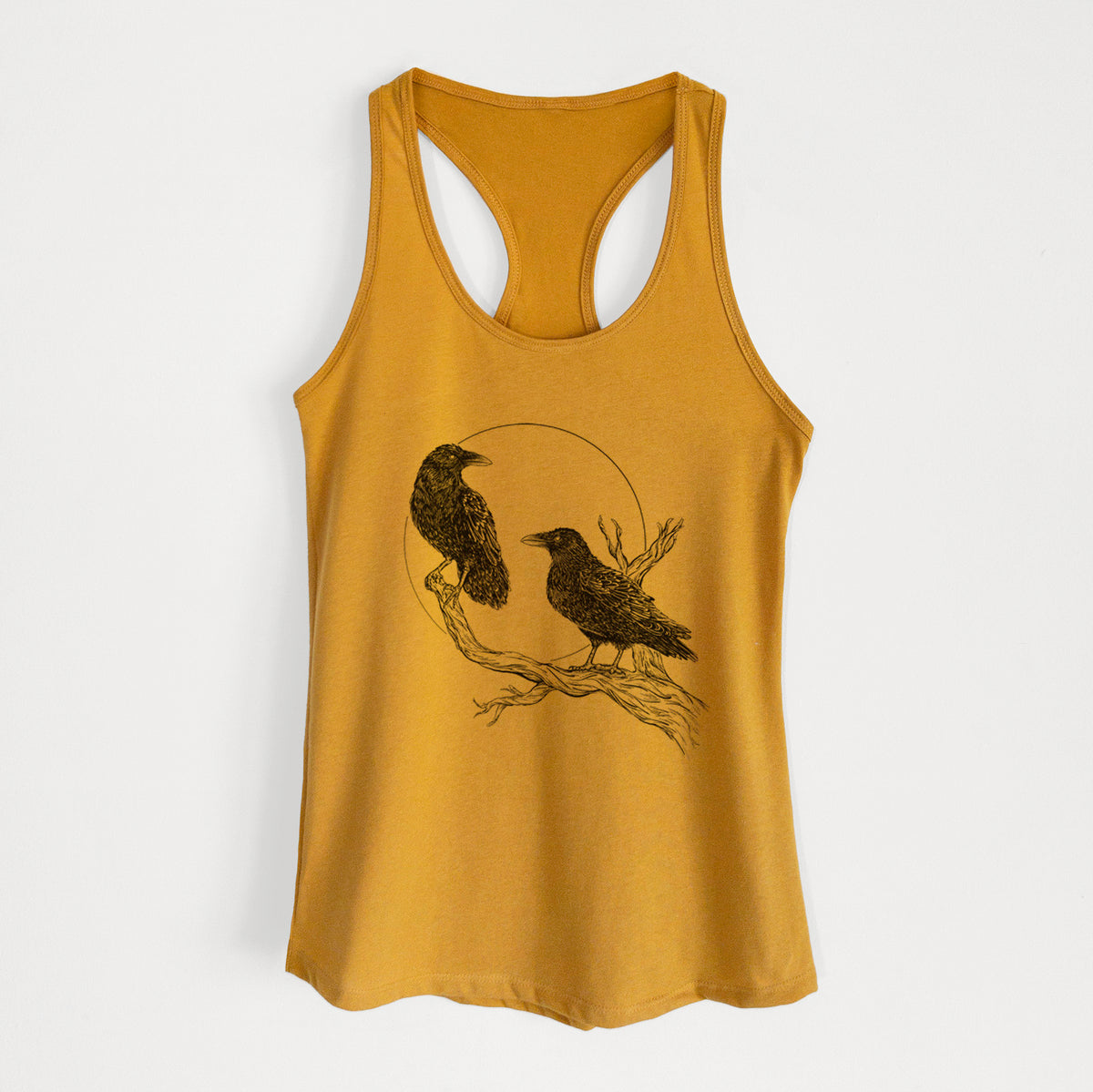 Gold women's racerback tank top laid flat, printed with a black ink illustration of two ravens perched on a branch in front of a full moon.
