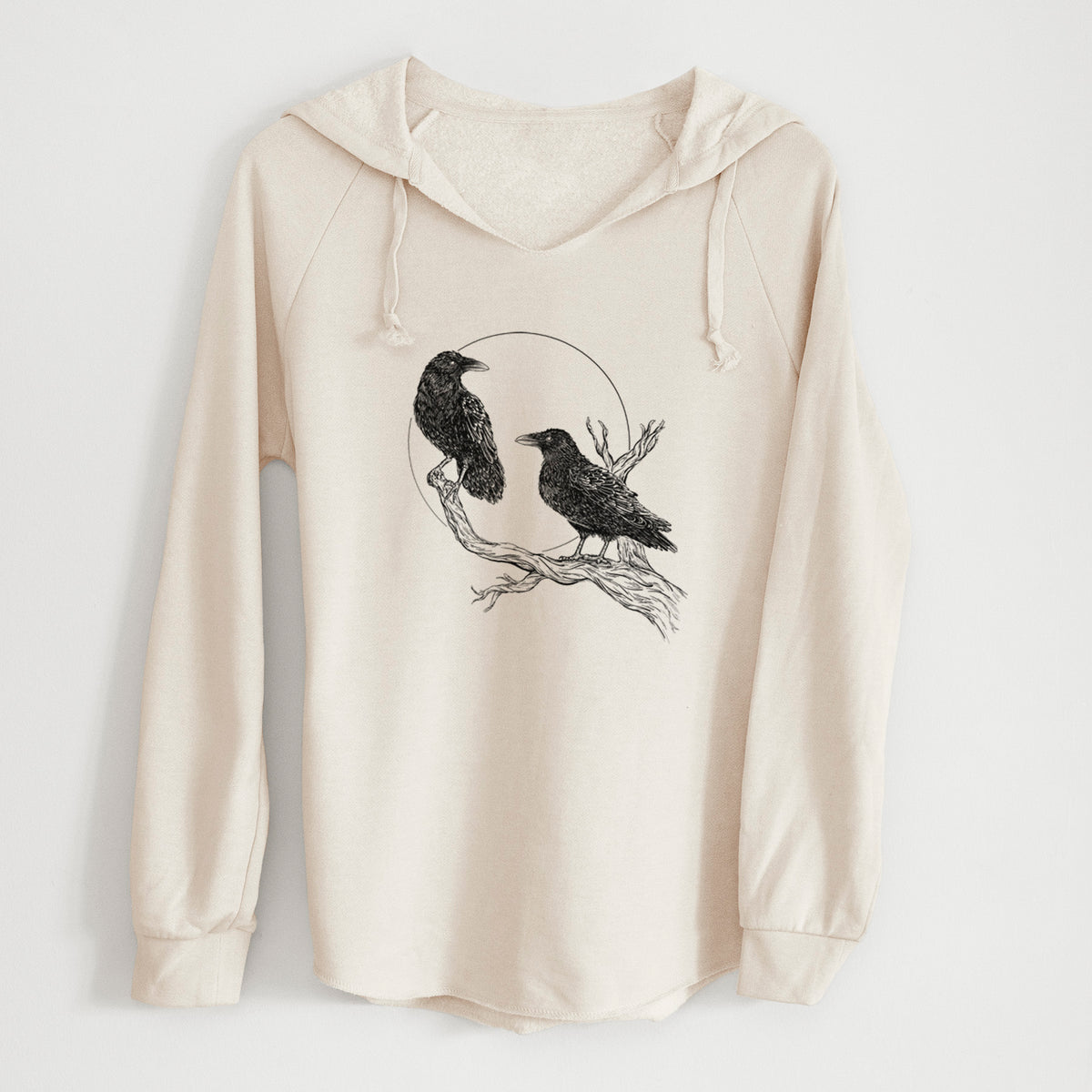 Bone cream women's Cali Wave hooded sweatshirt laid flat, printed with a black ink illustration of two ravens perched on a branch in front of a full moon.