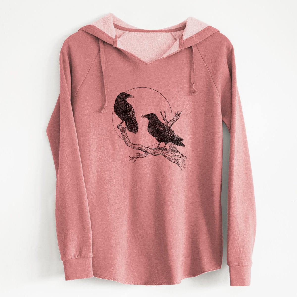 Dusty rose women's Cali Wave hooded sweatshirt laid flat, printed with a black ink illustration of two ravens perched on a branch in front of a full moon.