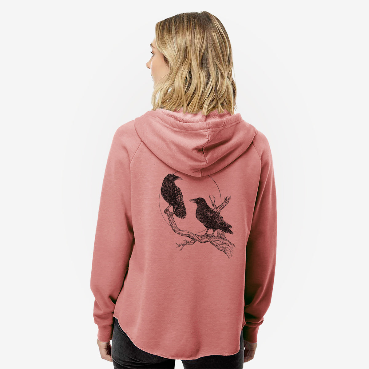Woman wearing a dusty rose women's Cali Wave zip-up sweatshirt printed with a black ink illustration of two ravens perched on a branch in front of a full moon, seen from behind.
