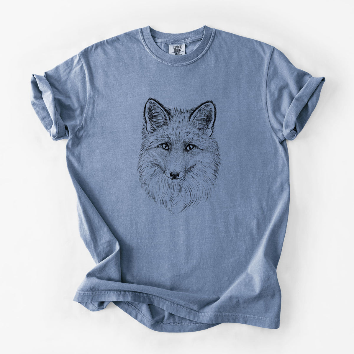 Blue jean Comfort Colors t-shirt laid flat, printed with a detailed black ink sketch of a red fox's face looking straight ahead, its fur drawn in fine pencil-like strokes.