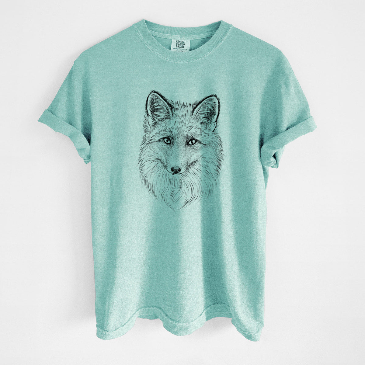 Chalky mint Comfort Colors t-shirt laid flat, printed with a detailed black ink sketch of a red fox's face looking straight ahead, its fur drawn in fine pencil-like strokes.