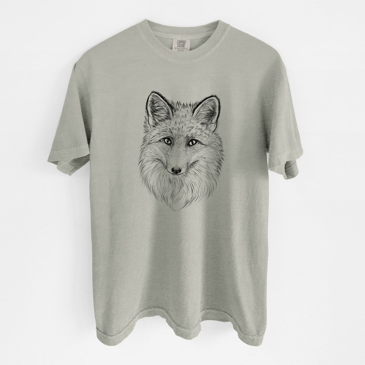 Sandstone beige Comfort Colors t-shirt laid flat, printed with a detailed black ink sketch of a red fox's face looking straight ahead, its fur drawn in fine pencil-like strokes.
