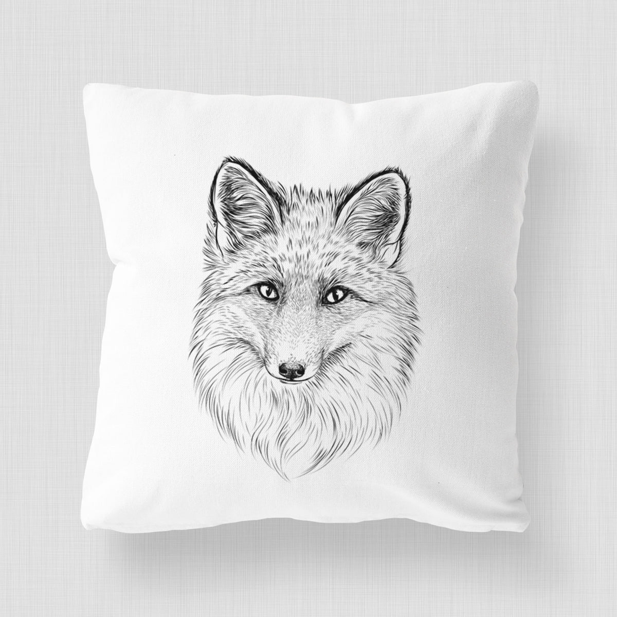 White pillow cover printed with a detailed black ink sketch of a red fox's face looking straight ahead, its fur drawn in fine pencil-like strokes.