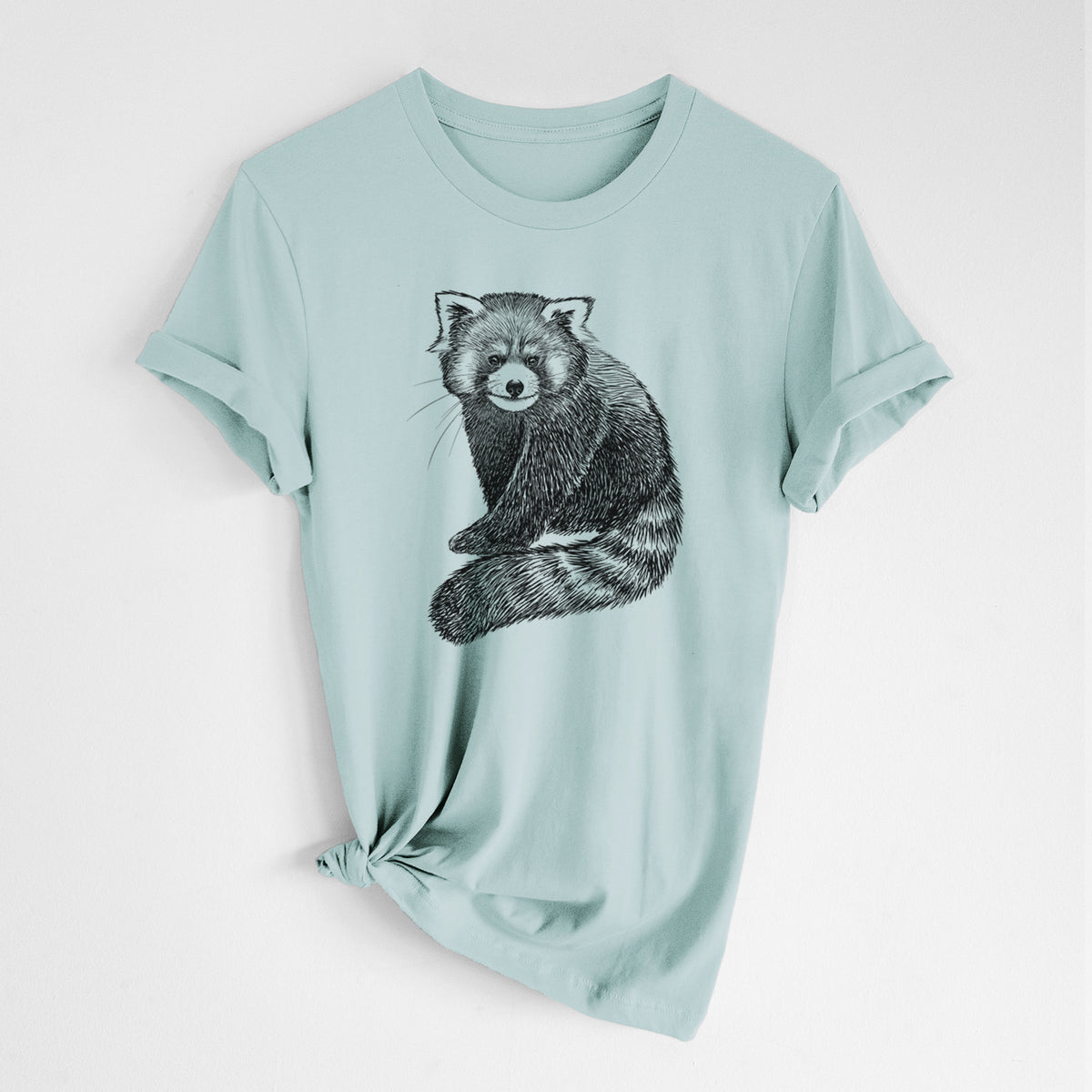 Dusty blue lightweight cotton t-shirt laid flat with the sleeves rolled, printed with a detailed black ink illustration of a red panda sitting with its striped tail wrapped around.
