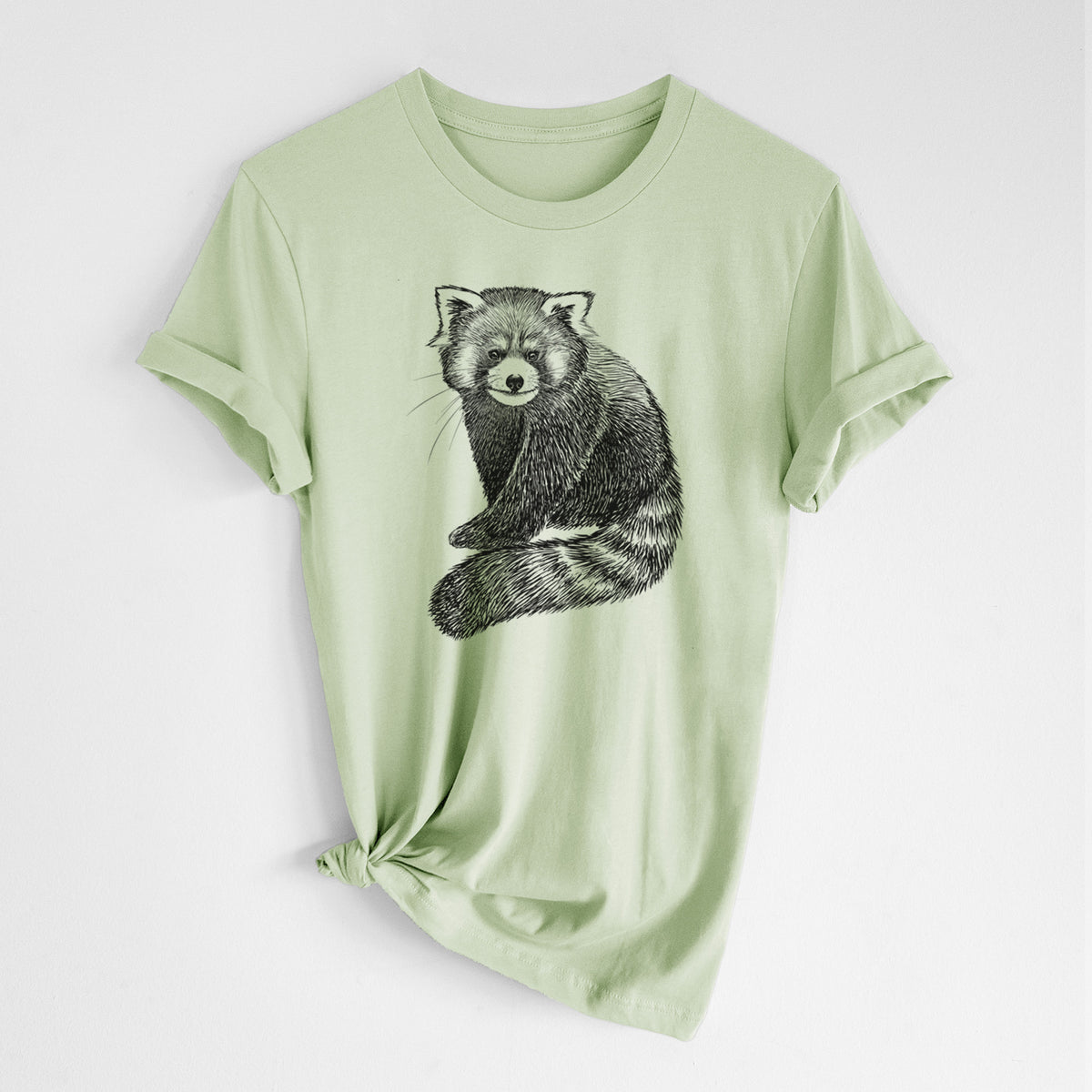 Spring green lightweight cotton t-shirt laid flat with the sleeves rolled, printed with a detailed black ink illustration of a red panda sitting with its striped tail wrapped around.
