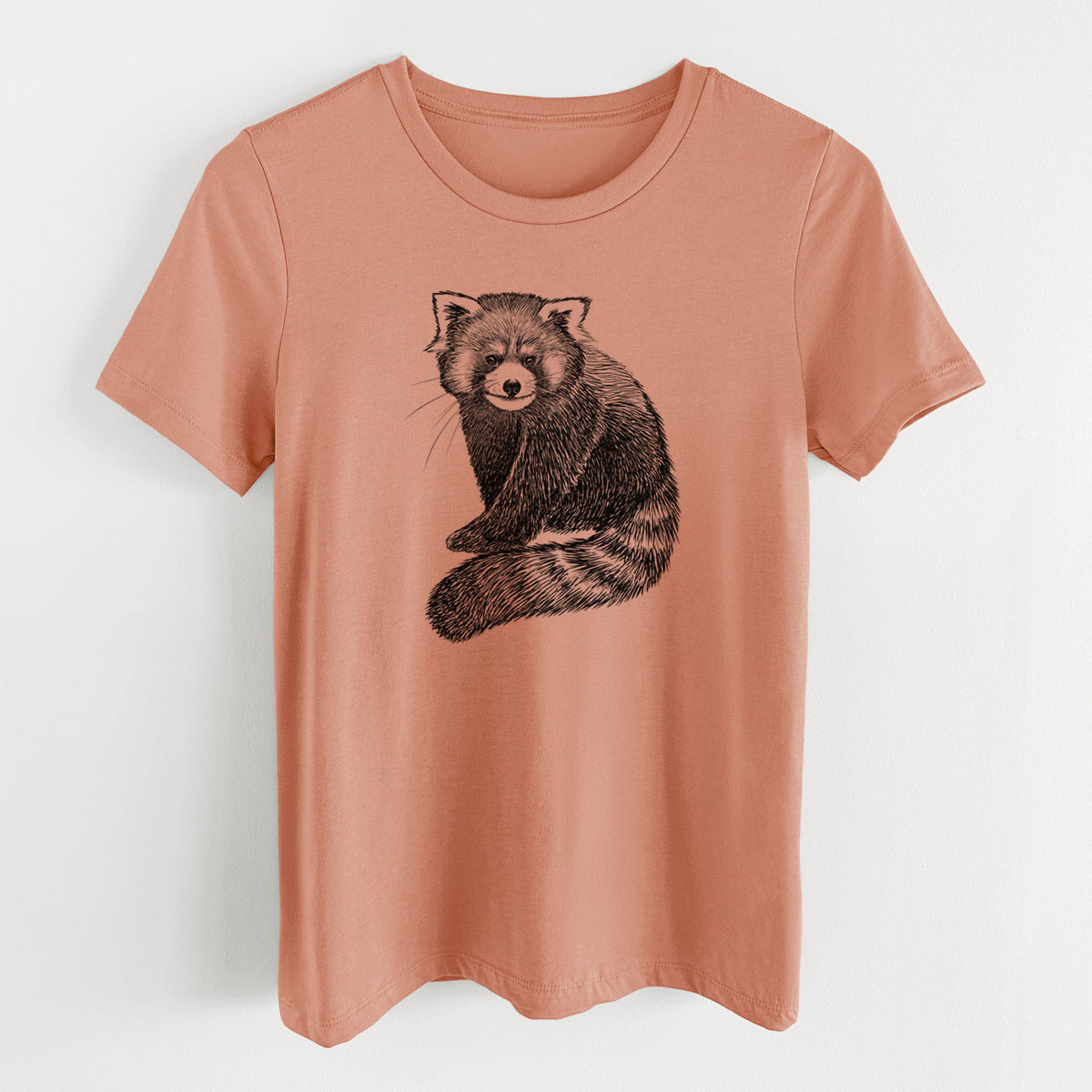 Terracotta orange women's relaxed fit cotton t-shirt laid flat, printed with a detailed black ink illustration of a red panda sitting with its striped tail wrapped around.