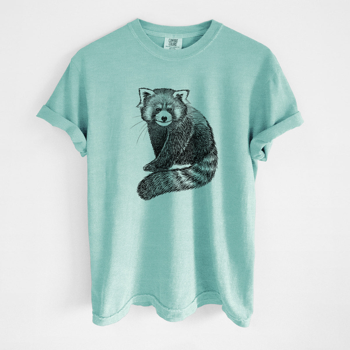 Chalky mint Comfort Colors t-shirt laid flat, printed with a detailed black ink illustration of a red panda sitting with its striped tail wrapped around.