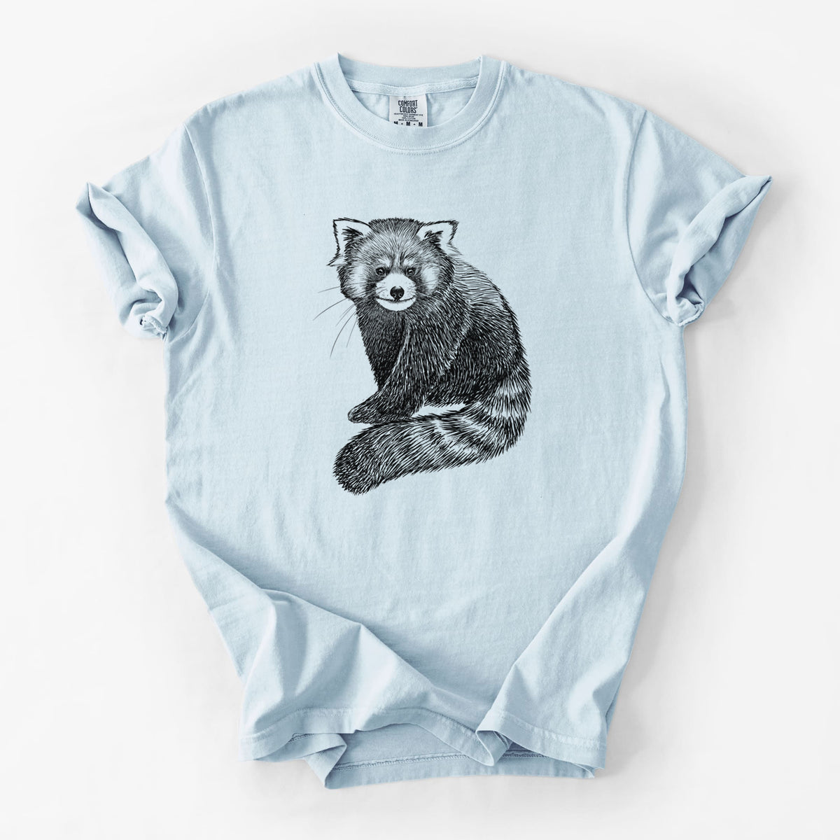 Chambray blue Comfort Colors t-shirt laid flat, printed with a detailed black ink illustration of a red panda sitting with its striped tail wrapped around.