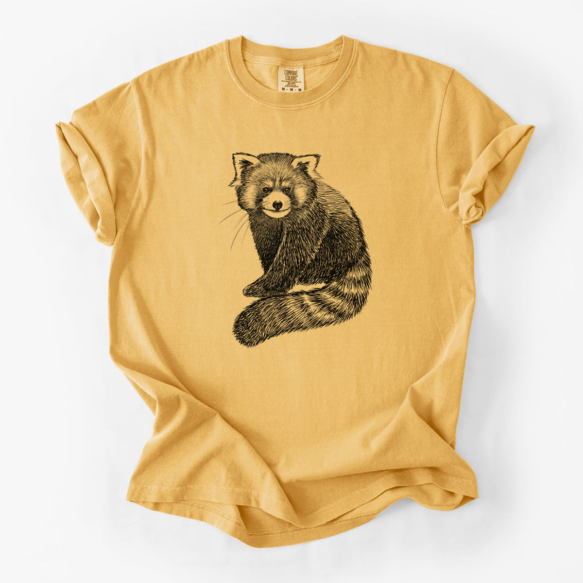 Golden wheat yellow Comfort Colors t-shirt laid flat, printed with a detailed black ink illustration of a red panda sitting with its striped tail wrapped around.