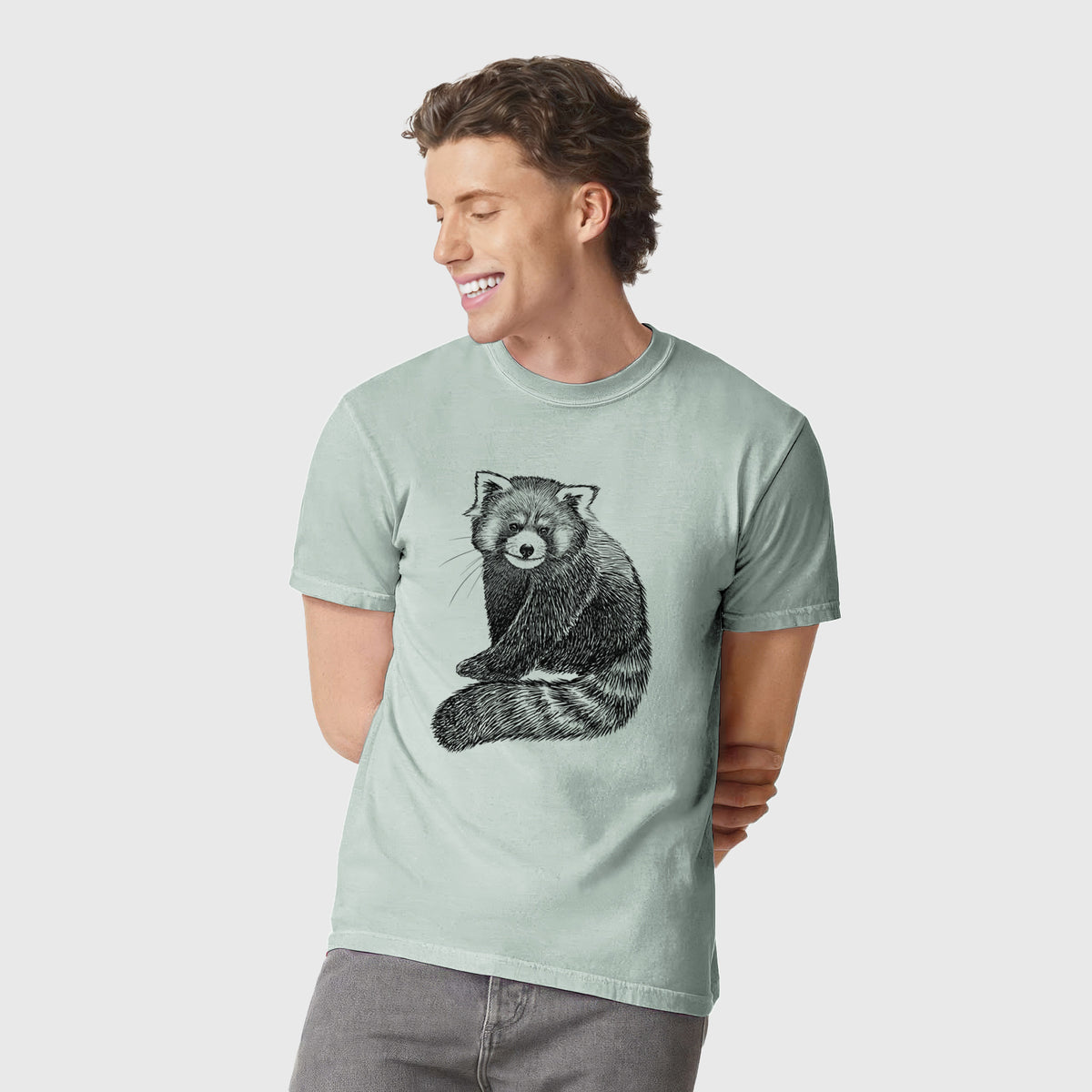 Man wearing a Comfort Colors t-shirt printed with a detailed black ink illustration of a red panda sitting with its striped tail wrapped around.