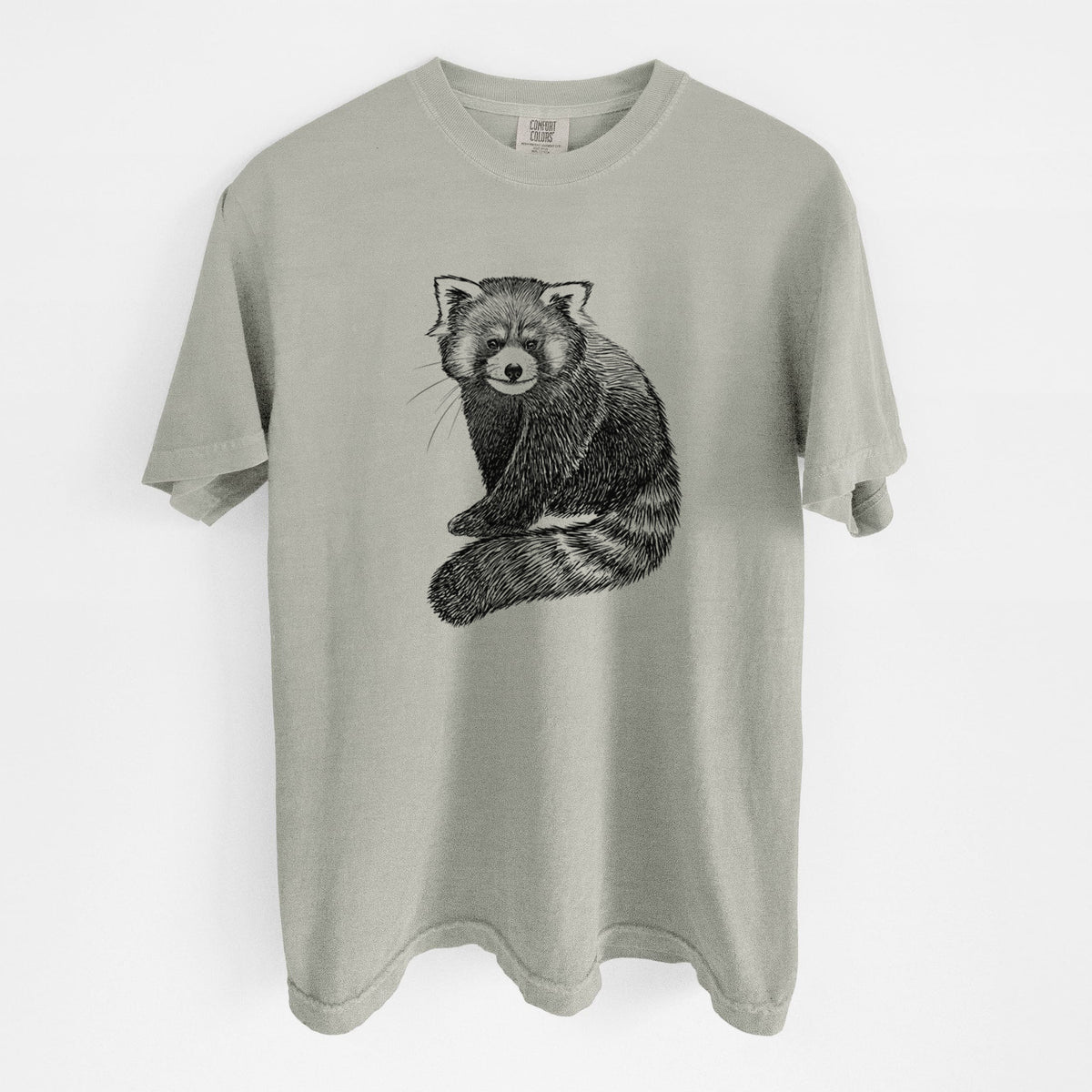 Sandstone beige Comfort Colors t-shirt laid flat, printed with a detailed black ink illustration of a red panda sitting with its striped tail wrapped around.