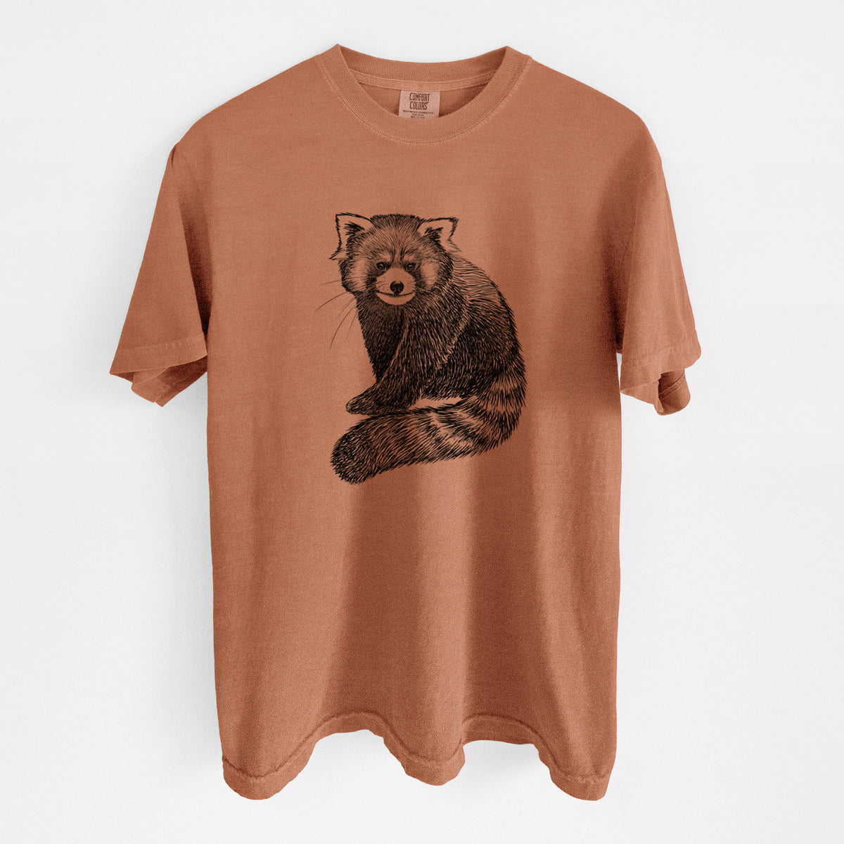 Yam burnt orange Comfort Colors t-shirt laid flat, printed with a detailed black ink illustration of a red panda sitting with its striped tail wrapped around.