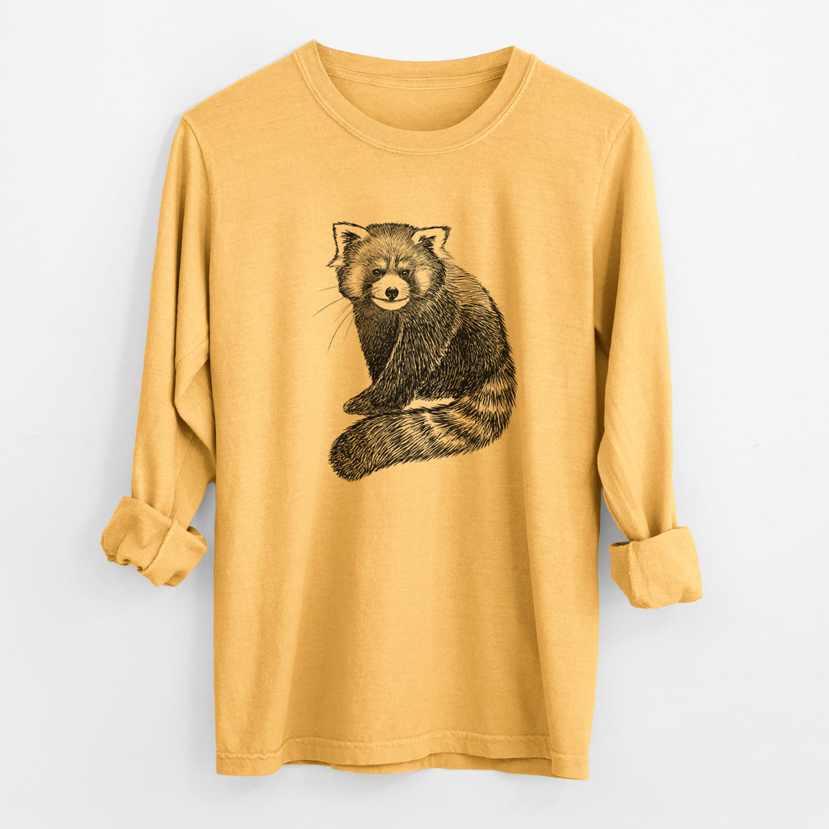 Golden wheat yellow Comfort Colors long sleeve shirt laid flat with the cuffs rolled, printed with a detailed black ink illustration of a red panda sitting with its striped tail wrapped around.