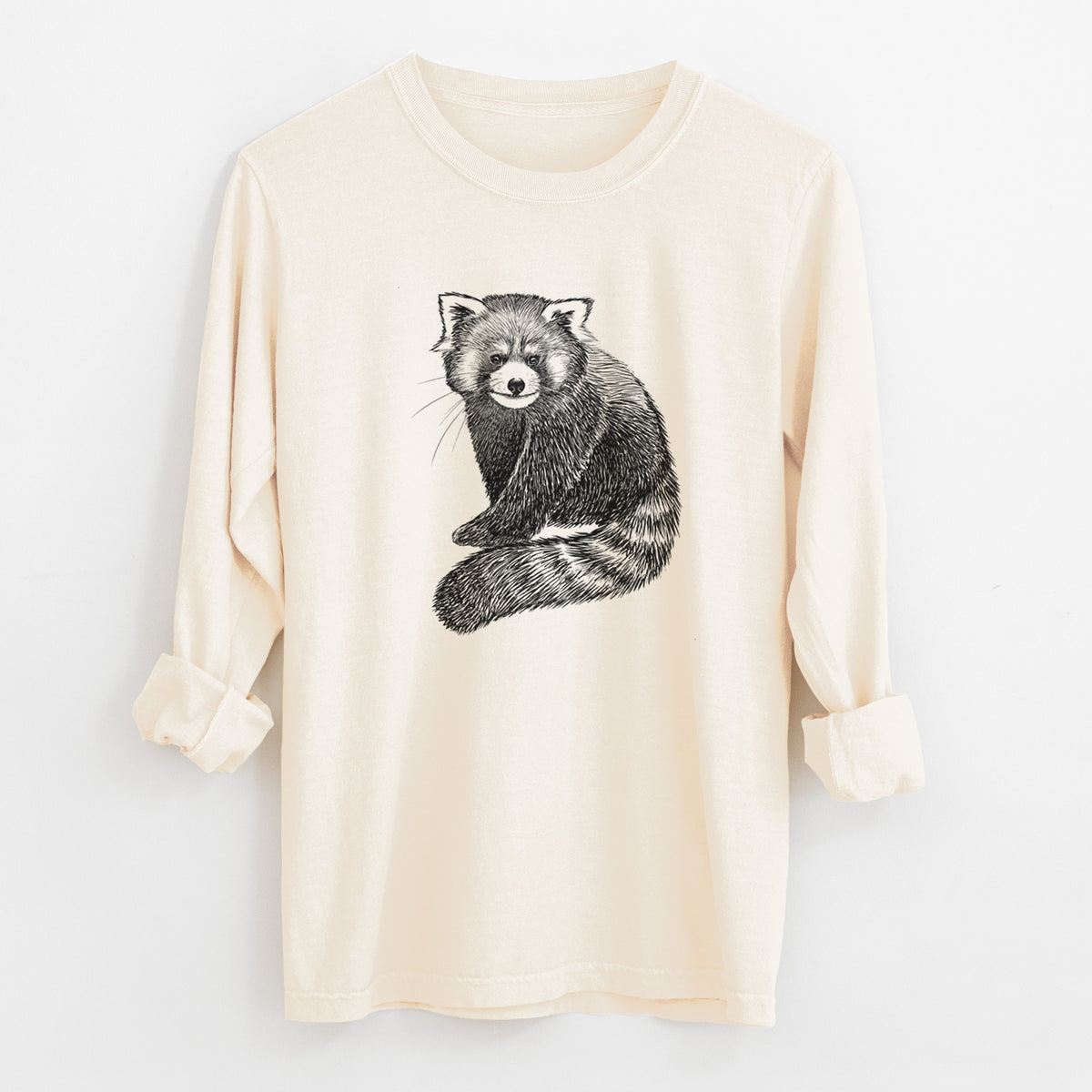Ivory Comfort Colors long sleeve shirt laid flat with the cuffs rolled, printed with a detailed black ink illustration of a red panda sitting with its striped tail wrapped around.