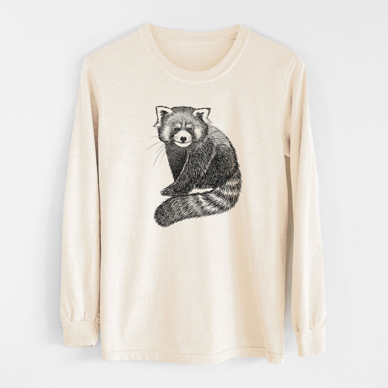 Ivory Comfort Colors long sleeve shirt laid flat, printed with a detailed black ink illustration of a red panda sitting with its striped tail wrapped around.