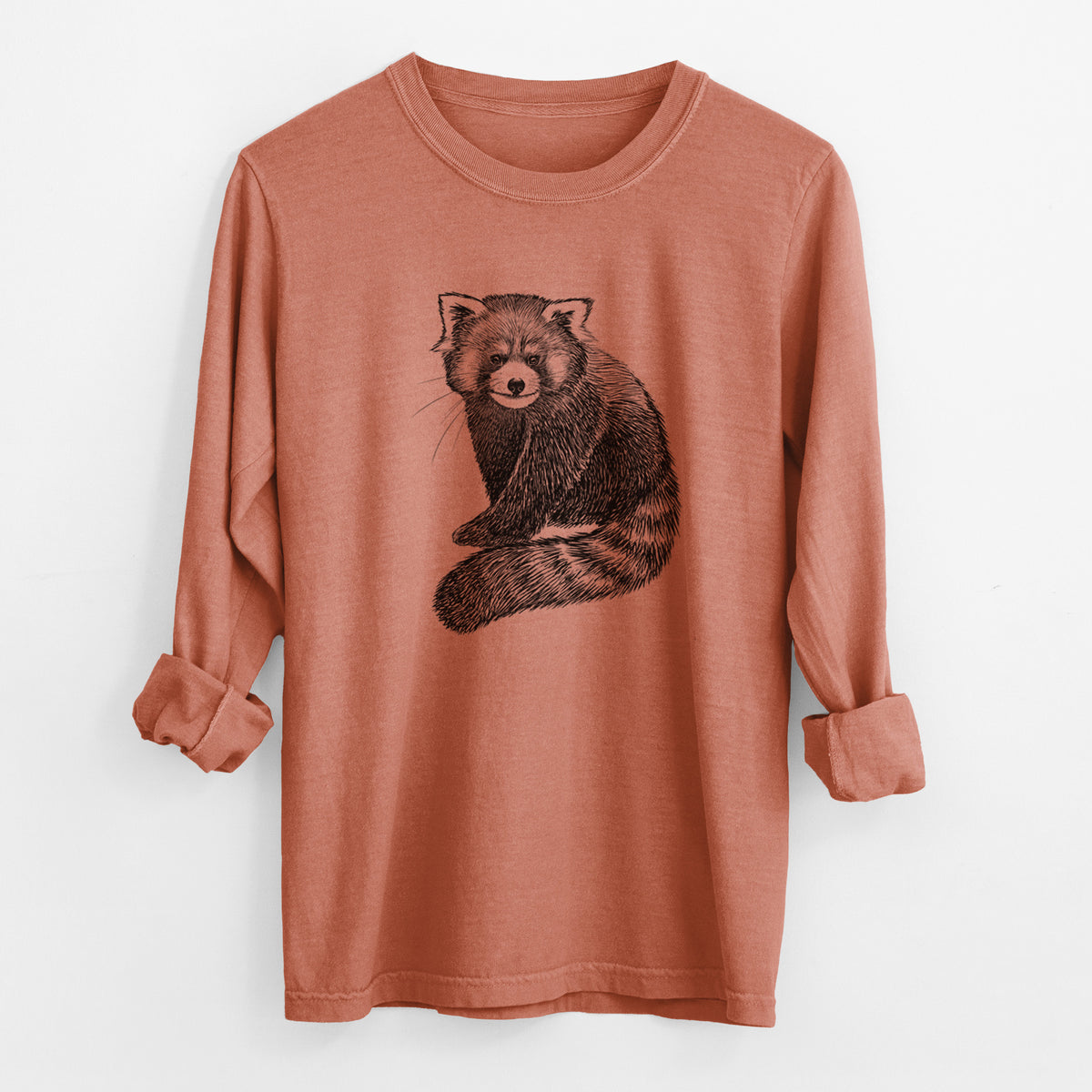 Yam burnt orange Comfort Colors long sleeve shirt laid flat with the cuffs rolled, printed with a detailed black ink illustration of a red panda sitting with its striped tail wrapped around.