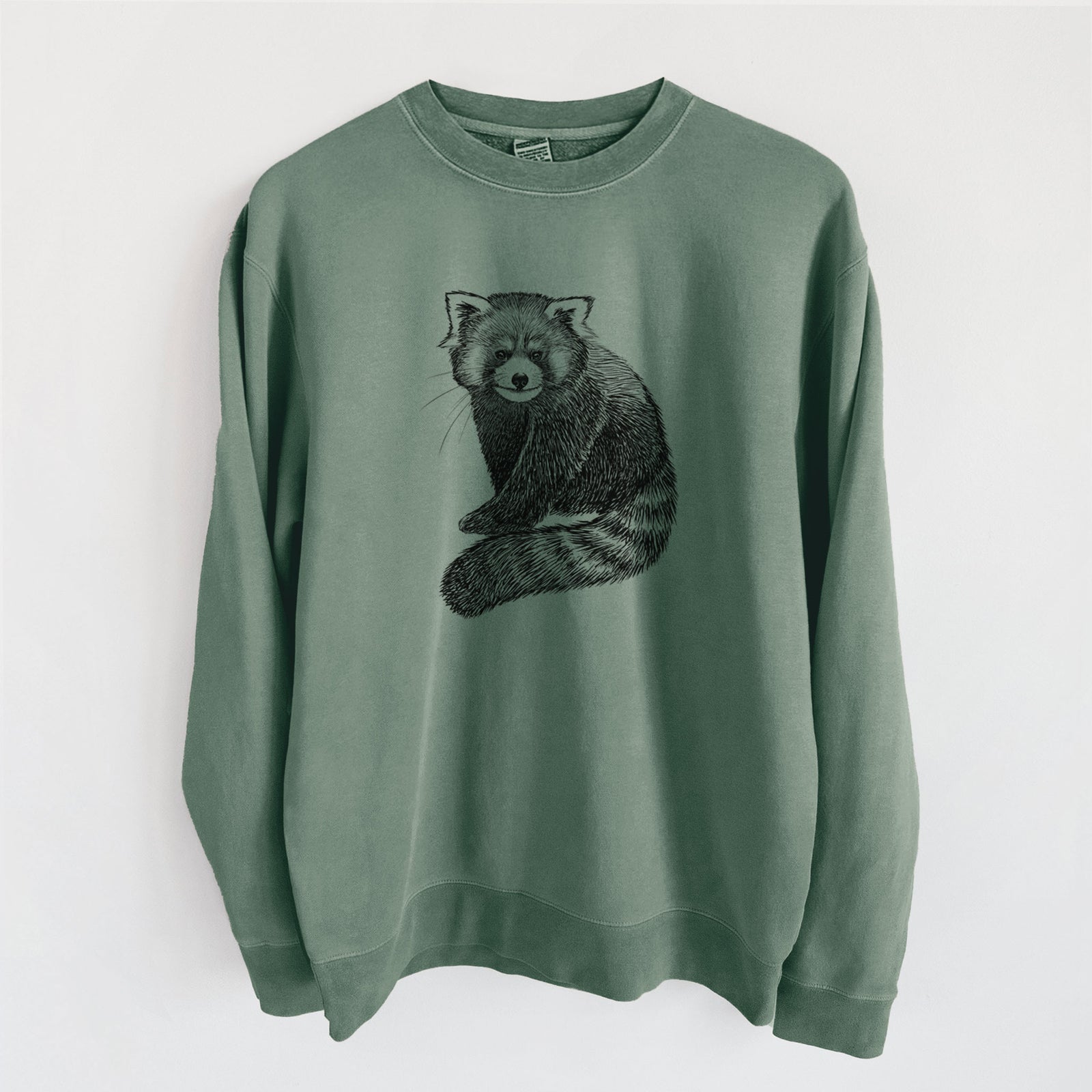Alpine green pigment dyed crewneck sweatshirt laid flat, printed with a detailed black ink illustration of a red panda sitting with its striped tail wrapped around.