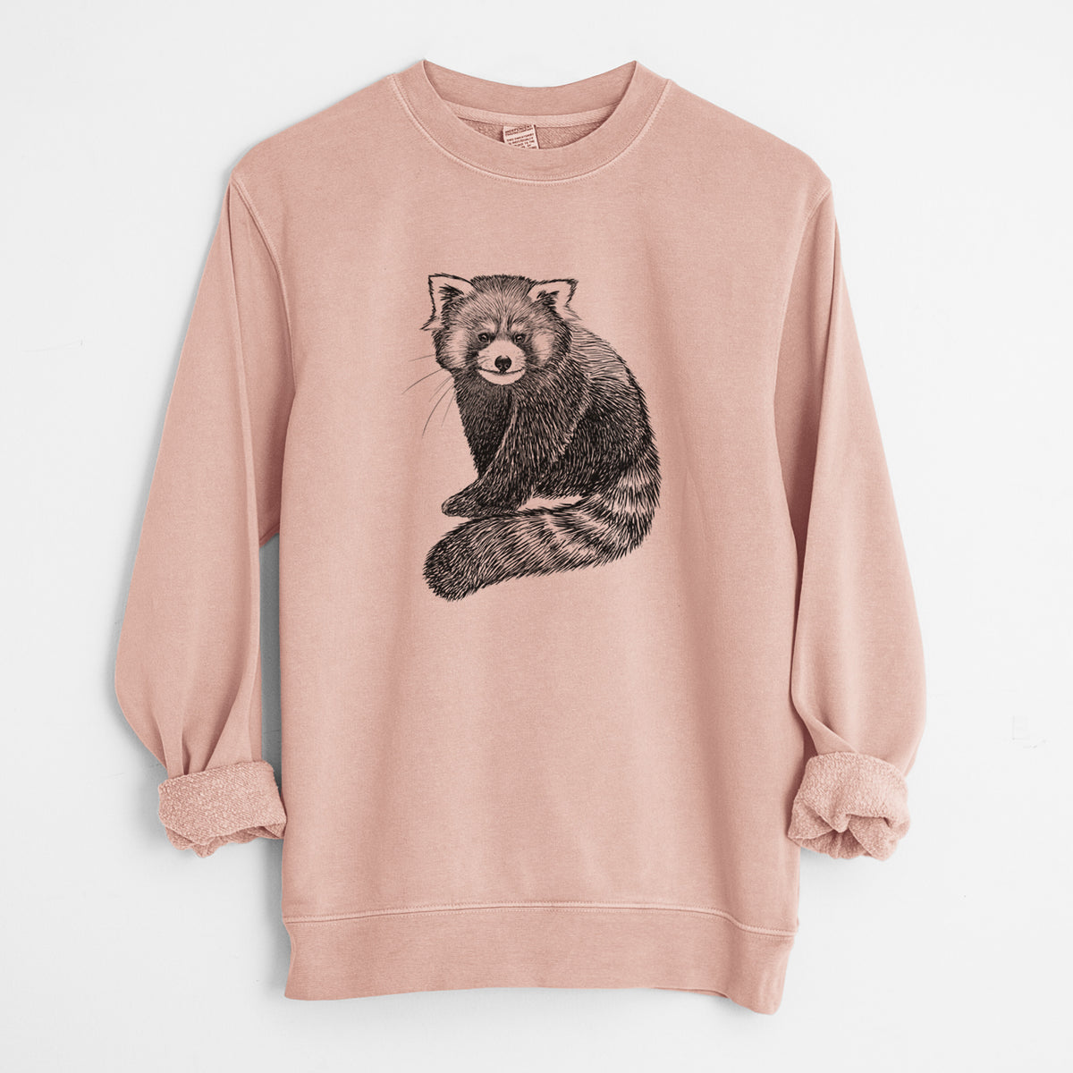 Dusty pink pigment dyed crewneck sweatshirt laid flat with the sleeves rolled, printed with a detailed black ink illustration of a red panda sitting with its striped tail wrapped around.