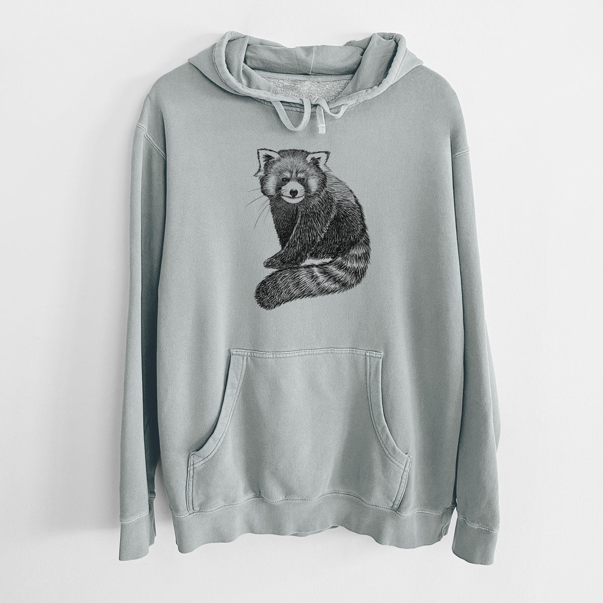 Sage green pigment dyed hoodie laid flat, printed with a detailed black ink illustration of a red panda sitting with its striped tail wrapped around.