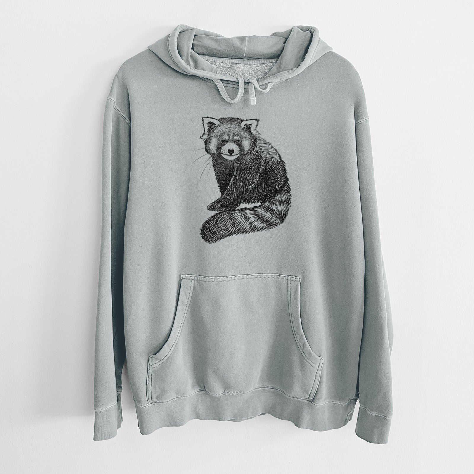 Sage green pigment dyed hoodie laid flat, printed with a detailed black ink illustration of a red panda sitting with its striped tail wrapped around.