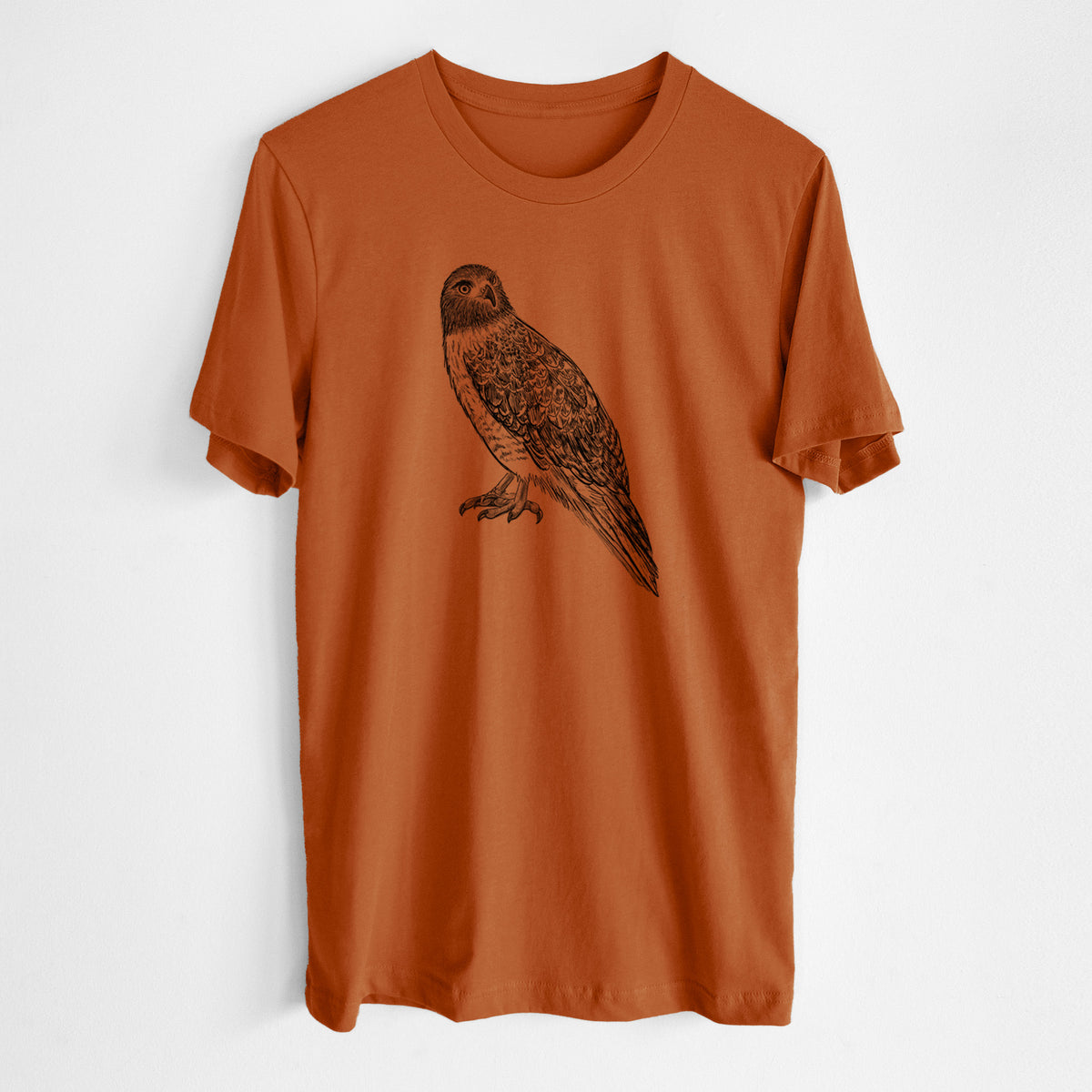Autumn lightweight cotton t-shirt laid flat, printed with a detailed black ink illustration of a red-tailed hawk perched.