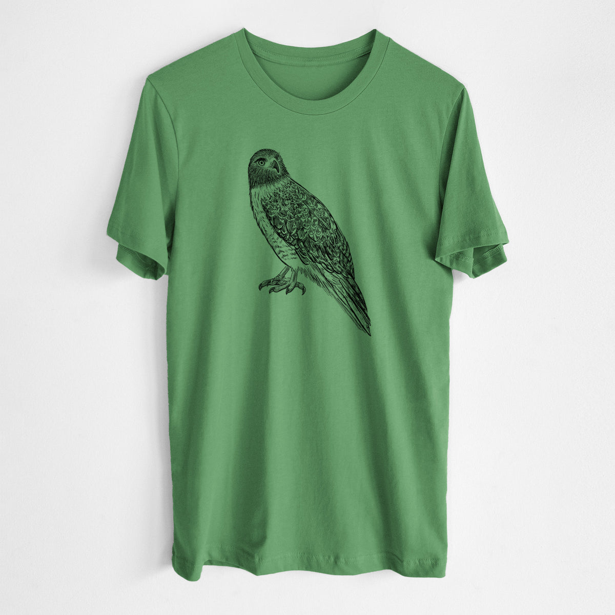 Leaf green lightweight cotton t-shirt laid flat, printed with a detailed black ink illustration of a red-tailed hawk perched.