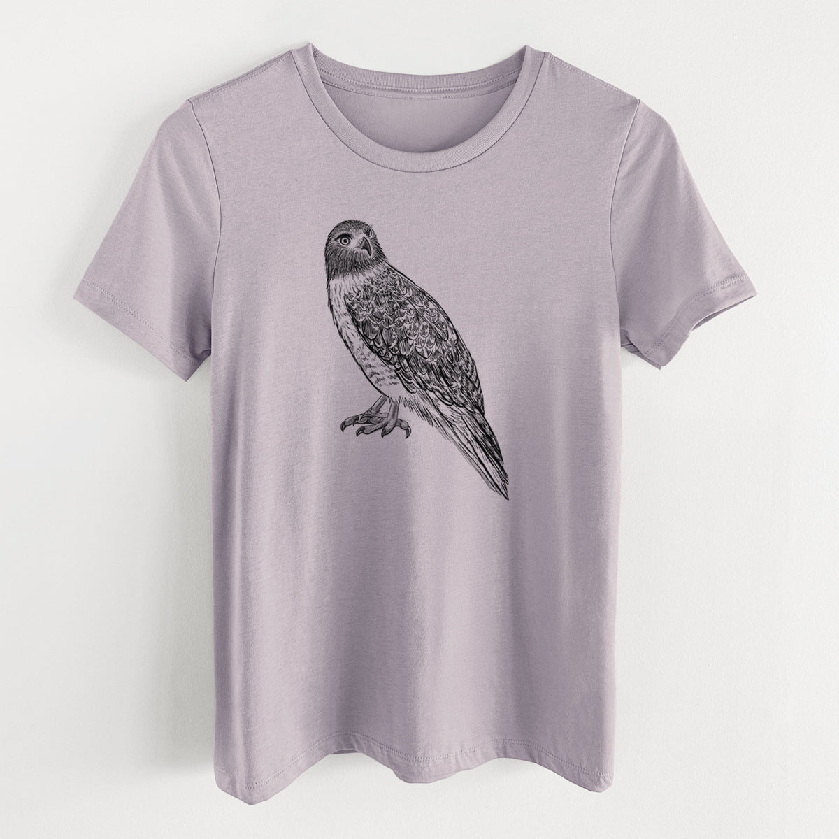 Light violet women's relaxed fit cotton t-shirt laid flat, printed with a detailed black ink illustration of a red-tailed hawk perched.