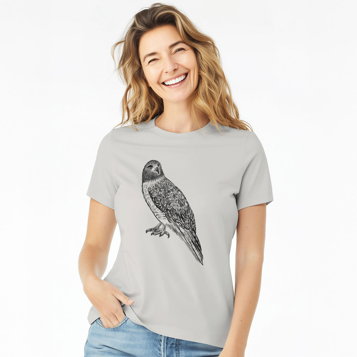 Woman wearing a lunar grey women's relaxed fit cotton t-shirt printed with a detailed black ink illustration of a red-tailed hawk perched.