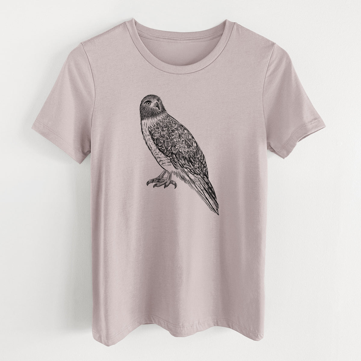Pink gravel women's relaxed fit cotton t-shirt laid flat, printed with a detailed black ink illustration of a red-tailed hawk perched.
