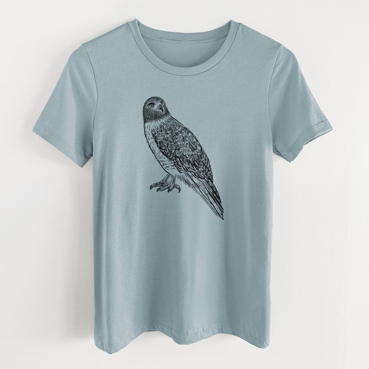 Vintage denim women's relaxed fit cotton t-shirt laid flat, printed with a detailed black ink illustration of a red-tailed hawk perched.