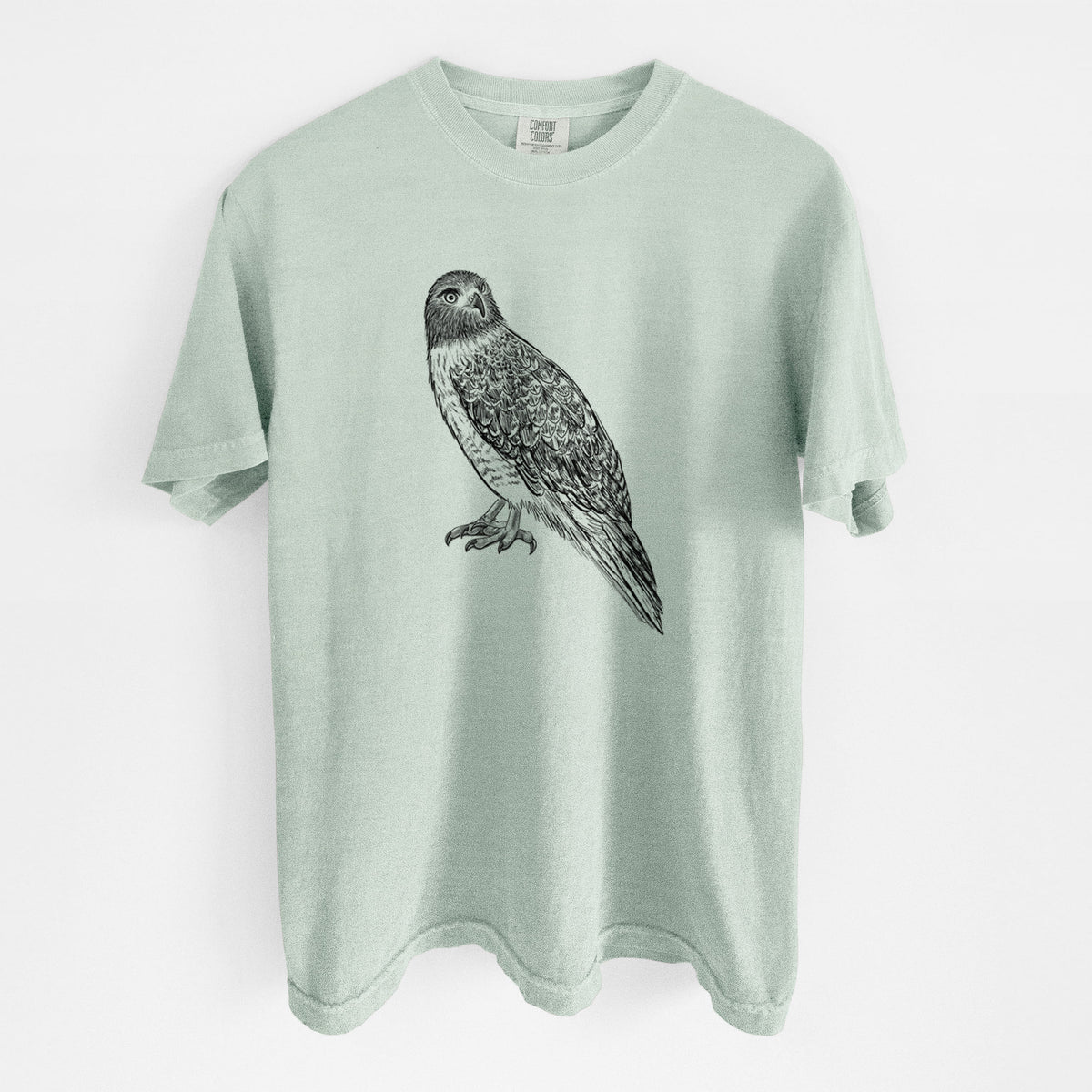 Bay green Comfort Colors t-shirt laid flat, printed with a detailed black ink illustration of a red-tailed hawk perched.