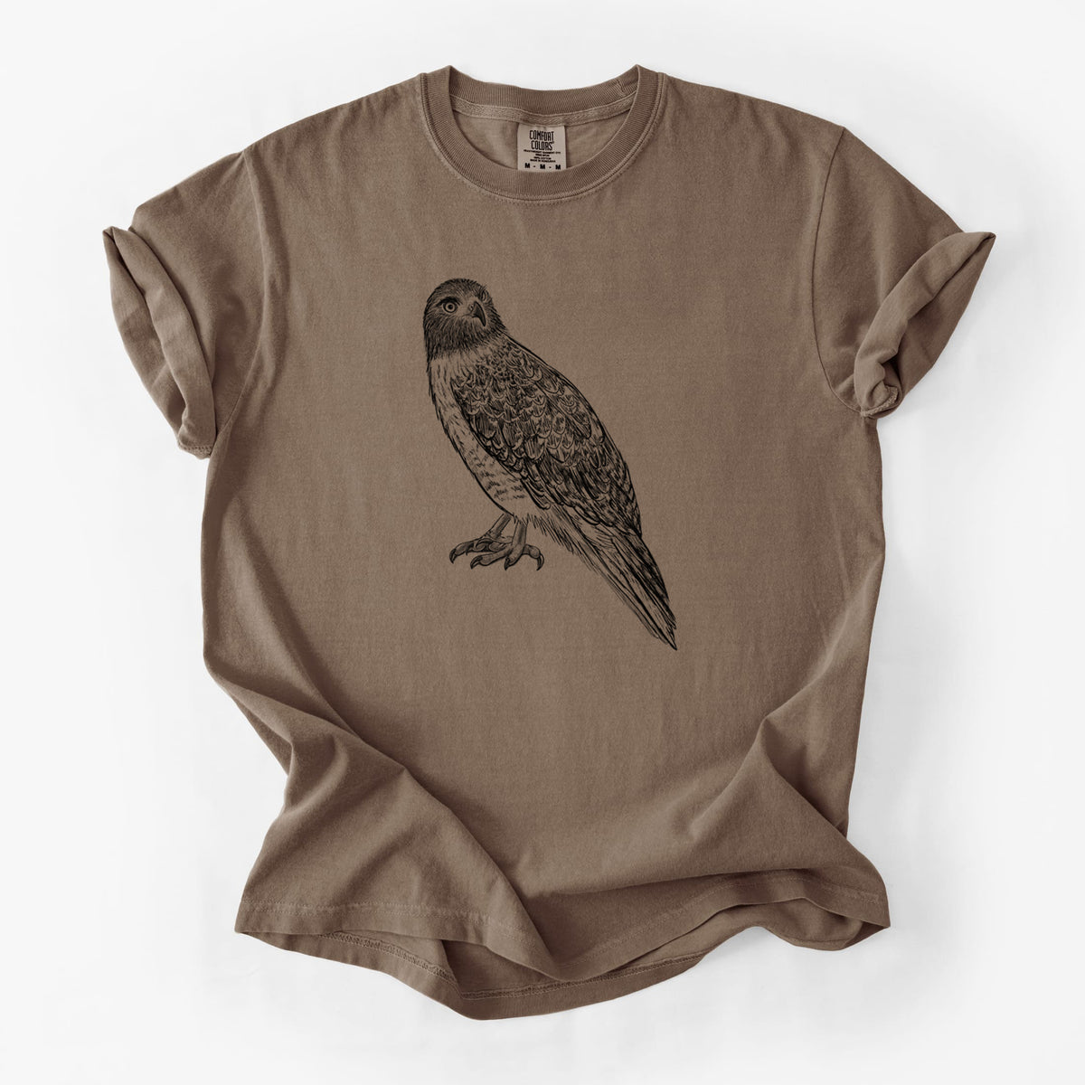 Espresso brown Comfort Colors t-shirt laid flat, printed with a detailed black ink illustration of a red-tailed hawk perched.