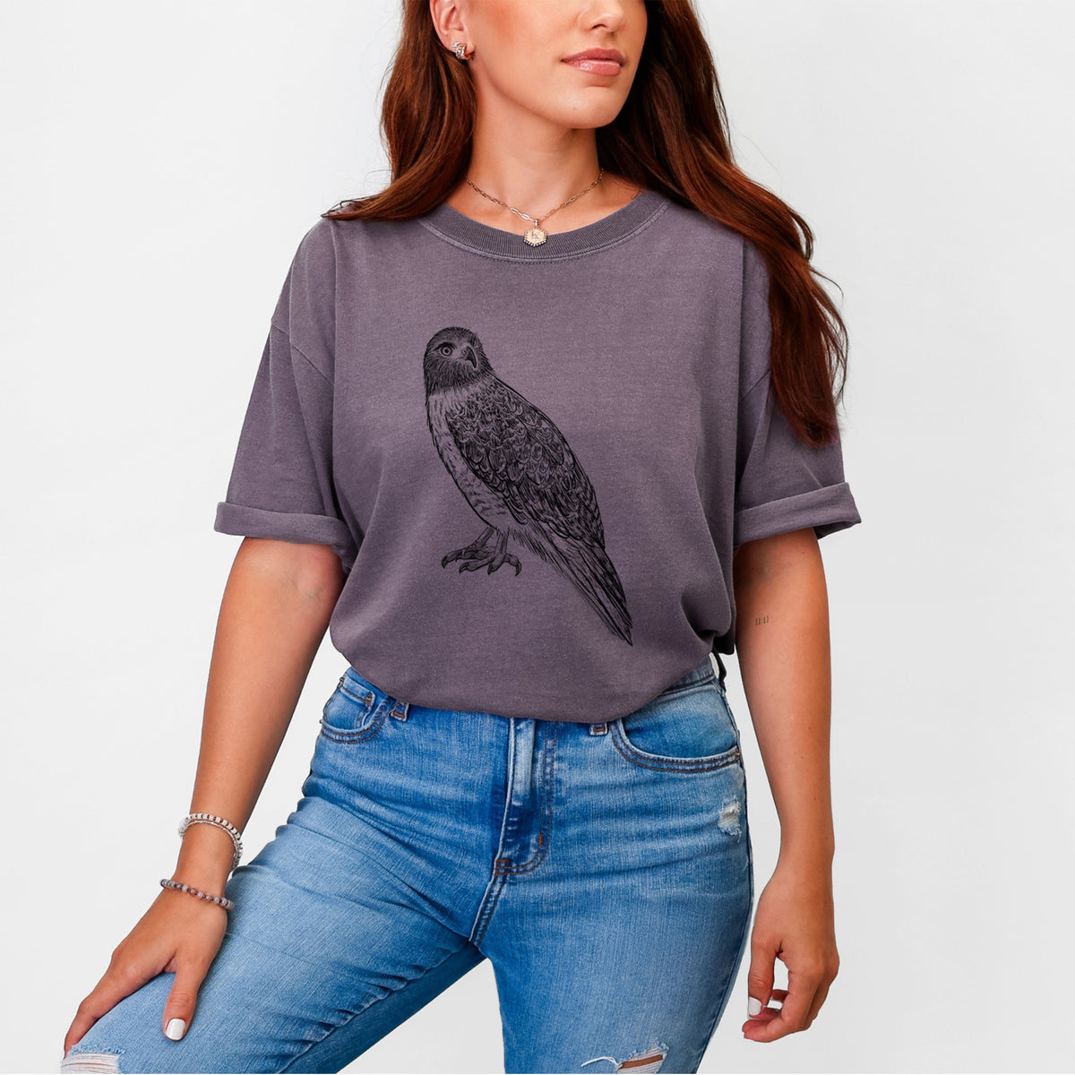 Woman wearing a Comfort Colors t-shirt printed with a detailed black ink illustration of a red-tailed hawk perched.