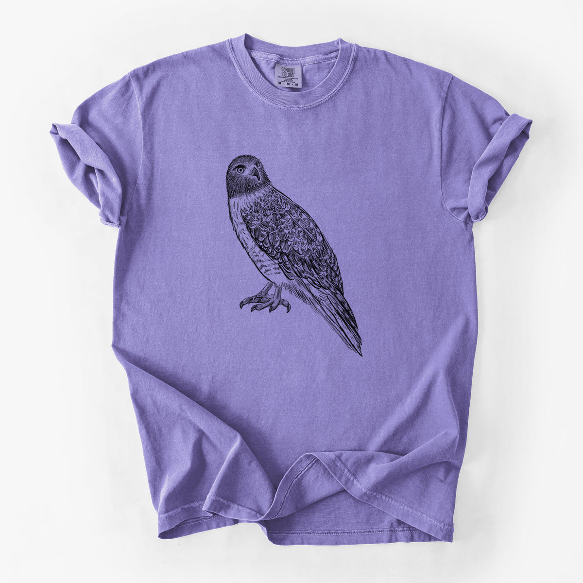 Violet purple Comfort Colors t-shirt laid flat, printed with a detailed black ink illustration of a red-tailed hawk perched.