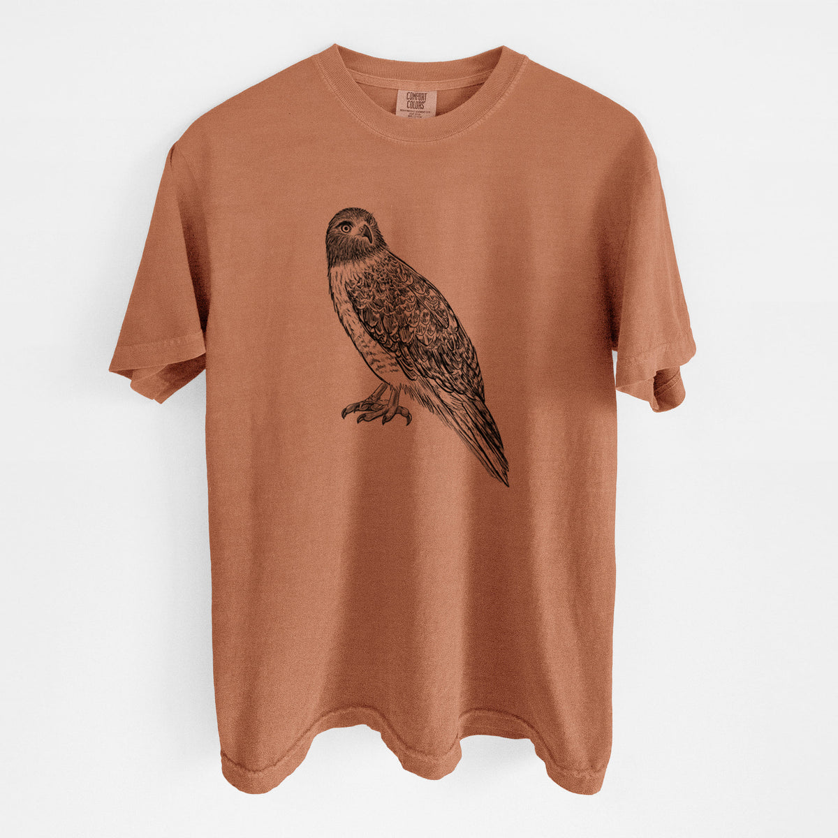 Yam burnt orange Comfort Colors t-shirt laid flat, printed with a detailed black ink illustration of a red-tailed hawk perched.