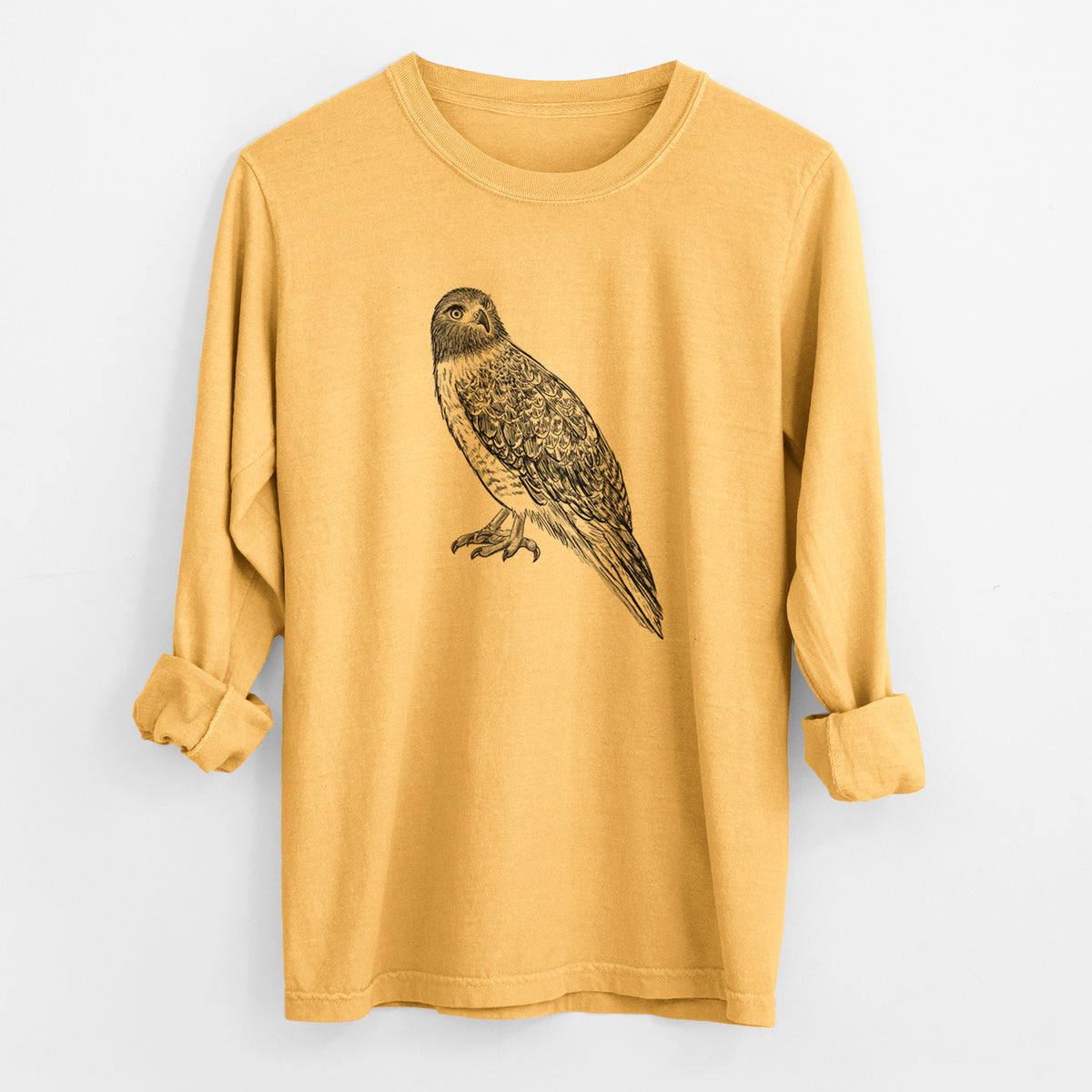 Golden wheat yellow Comfort Colors long sleeve shirt laid flat with the cuffs rolled, printed with a detailed black ink illustration of a red-tailed hawk perched.