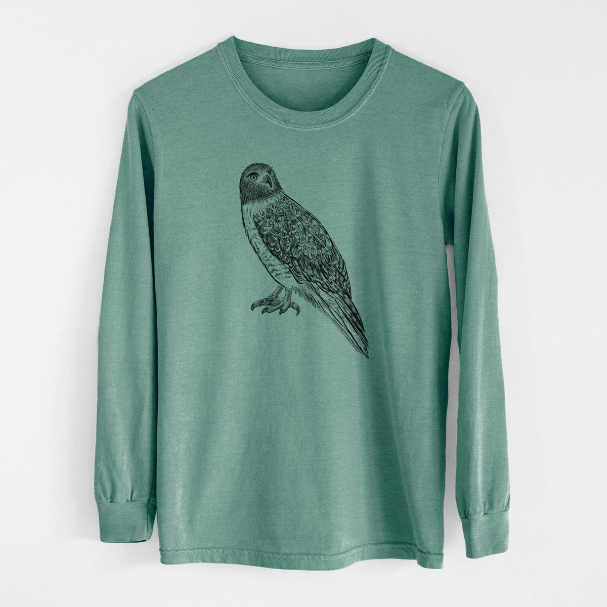 Pine green Comfort Colors long sleeve shirt laid flat, printed with a detailed black ink illustration of a red-tailed hawk perched.