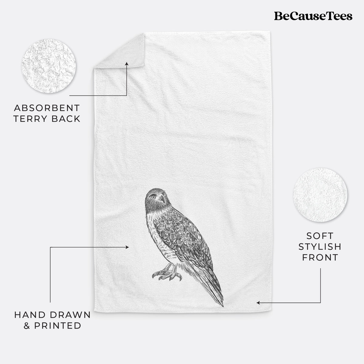 White hand towel printed with a detailed black ink illustration of a red-tailed hawk perched.