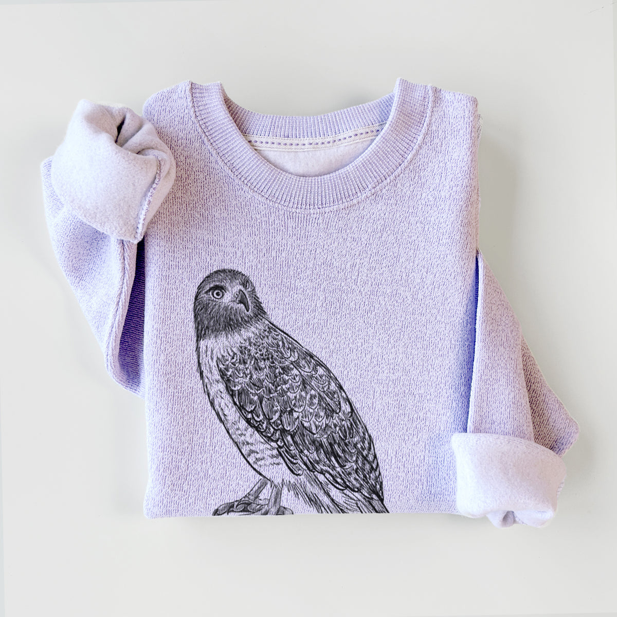 Ice purple knit sweatshirt printed with a detailed black ink illustration of a red-tailed hawk perched, styled flat.
