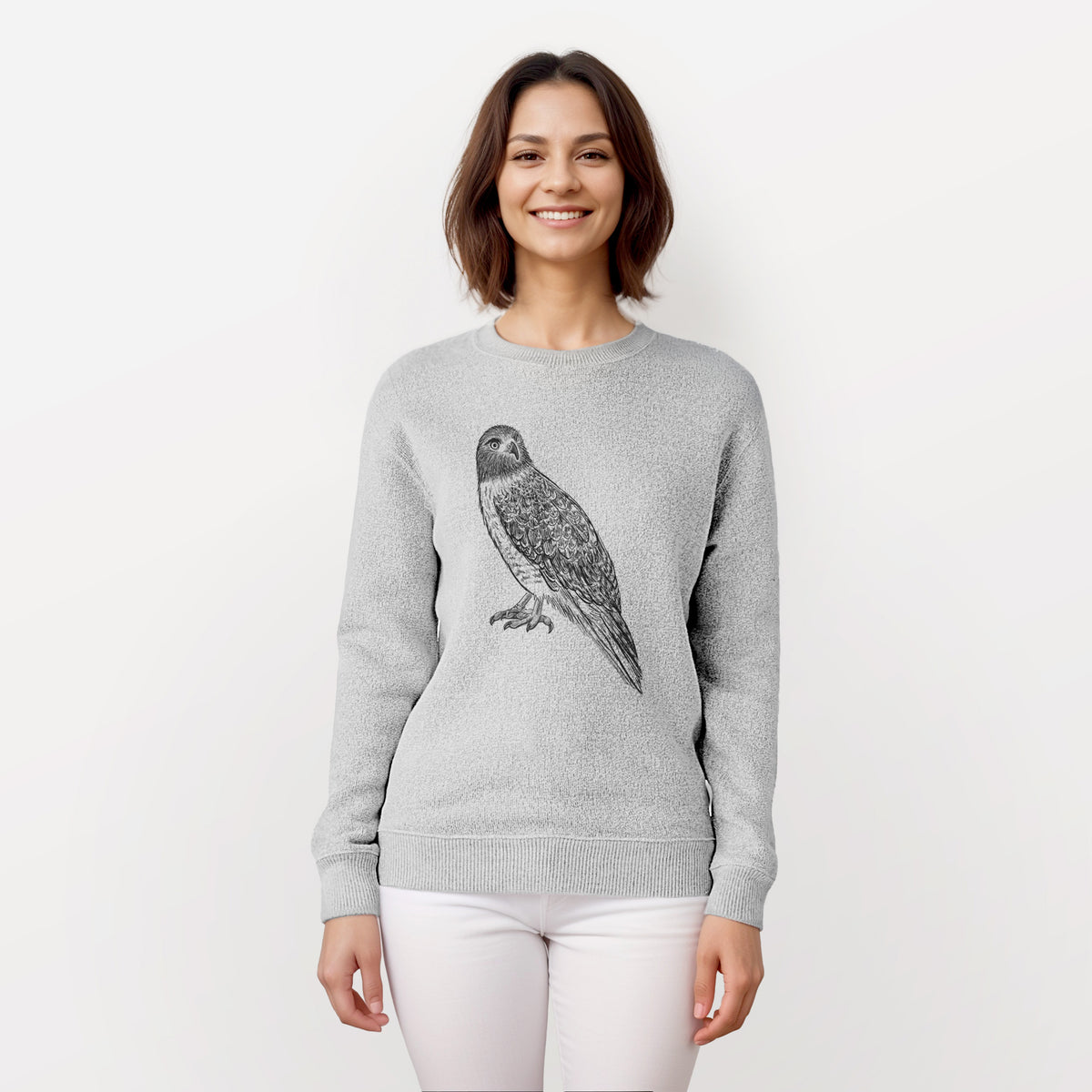 Woman wearing a knit sweatshirt printed with a detailed black ink illustration of a red-tailed hawk perched.