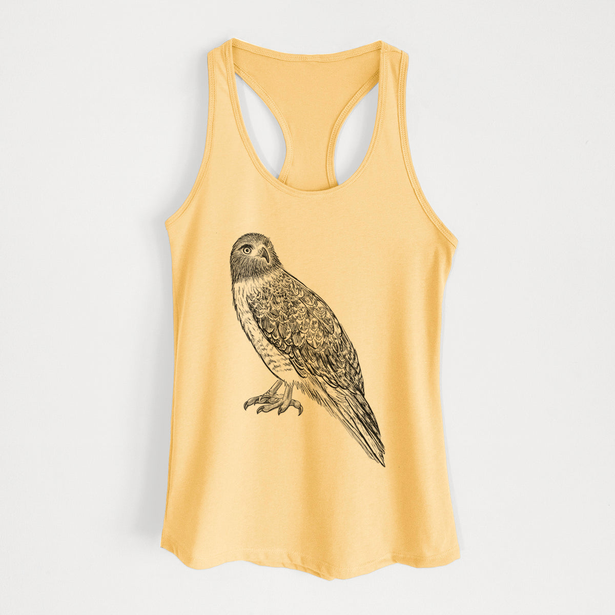 Banana cream women's racerback tank top laid flat, printed with a detailed black ink illustration of a red-tailed hawk perched.