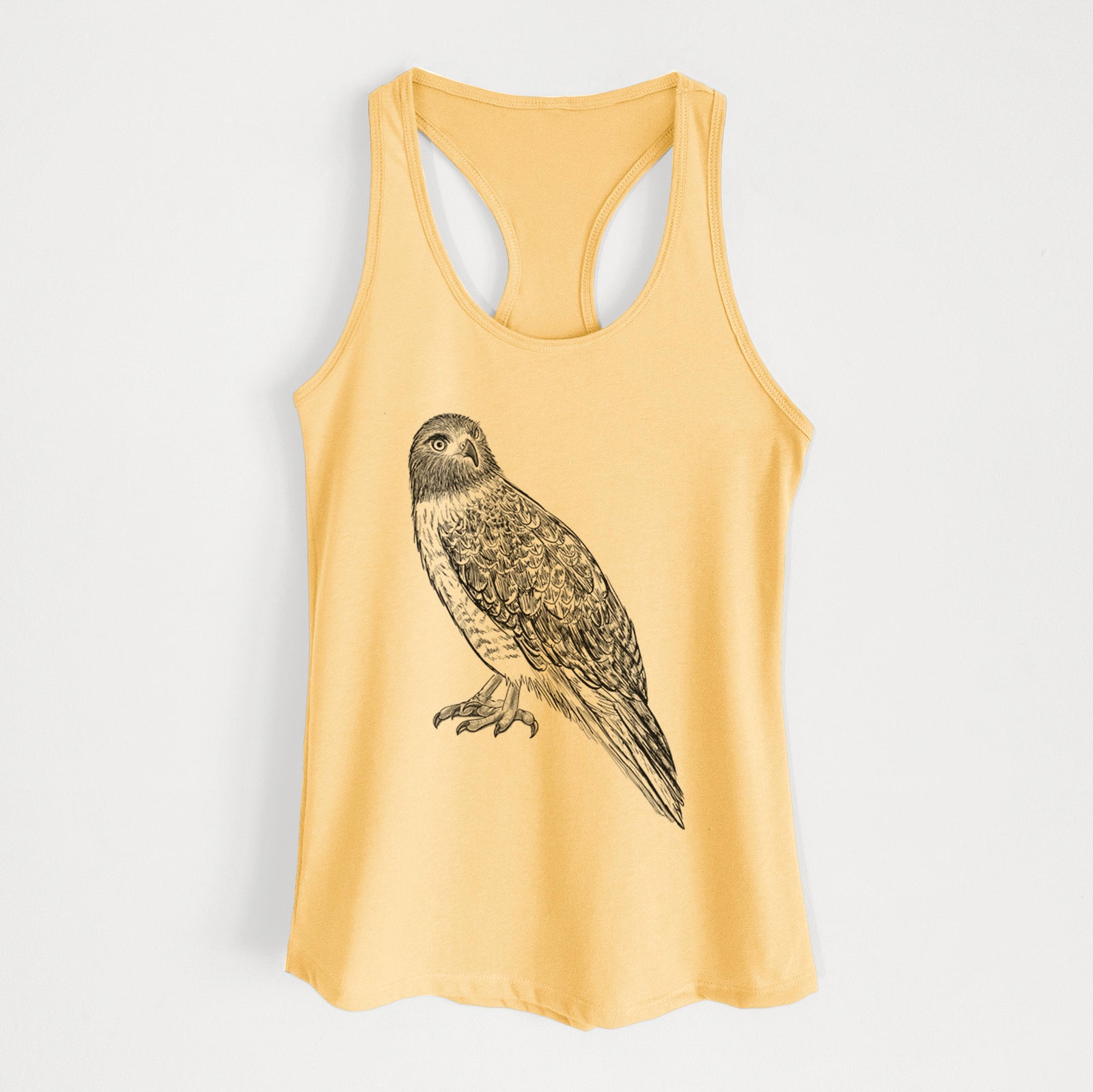 Banana cream women's racerback tank top laid flat, printed with a detailed black ink illustration of a red-tailed hawk perched.
