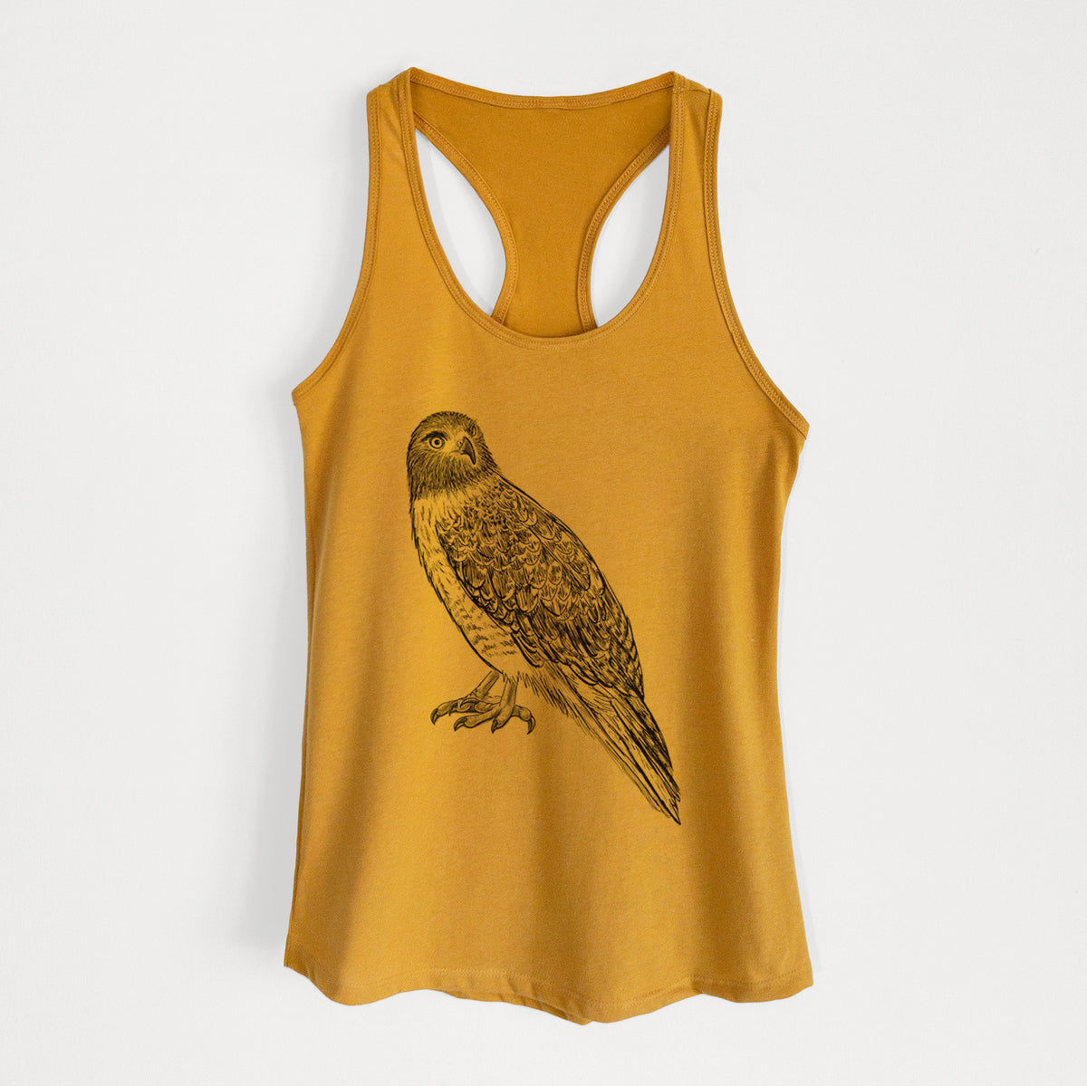 Gold women's racerback tank top laid flat, printed with a detailed black ink illustration of a red-tailed hawk perched.