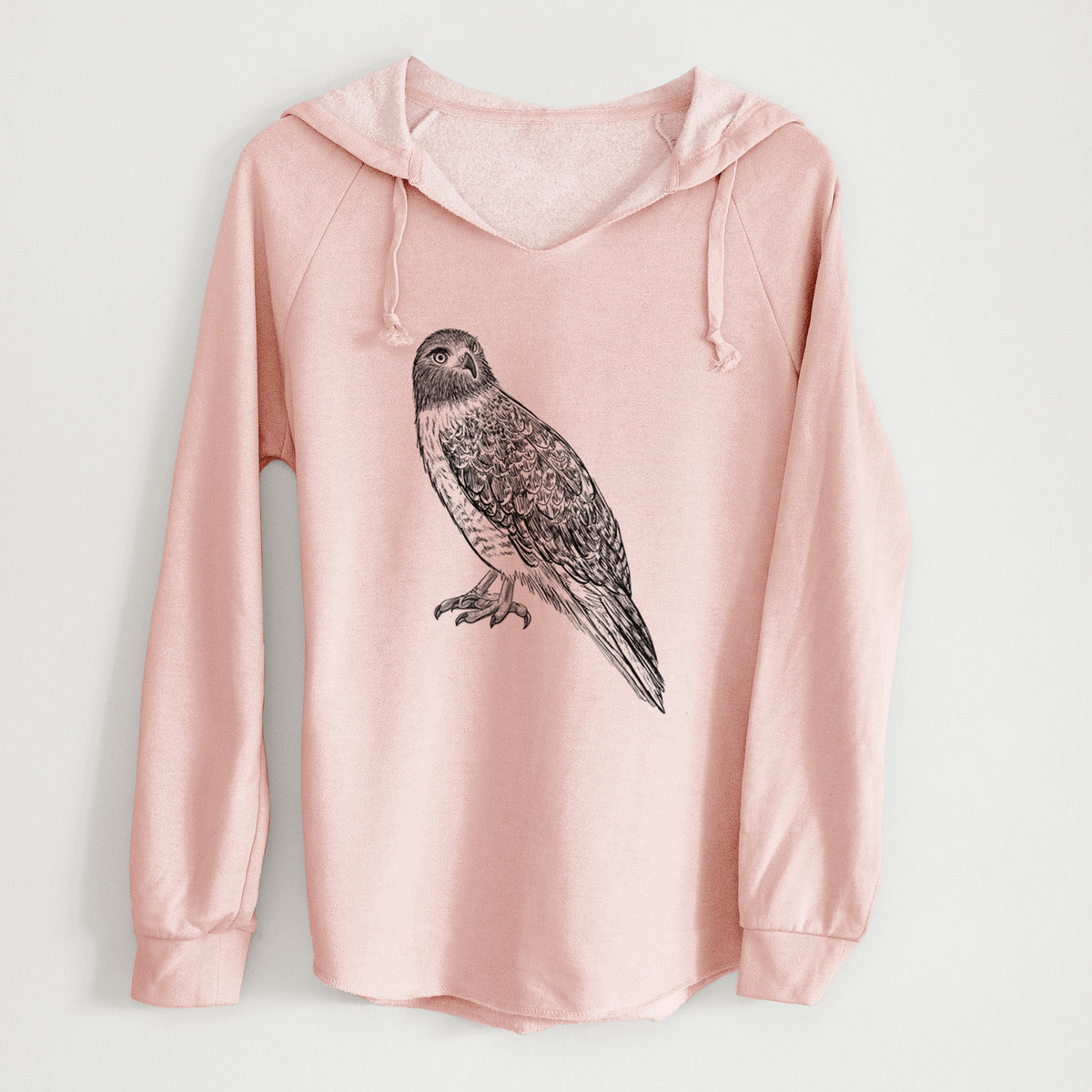 Blush pink women's Cali Wave hooded sweatshirt laid flat, printed with a detailed black ink illustration of a red-tailed hawk perched.