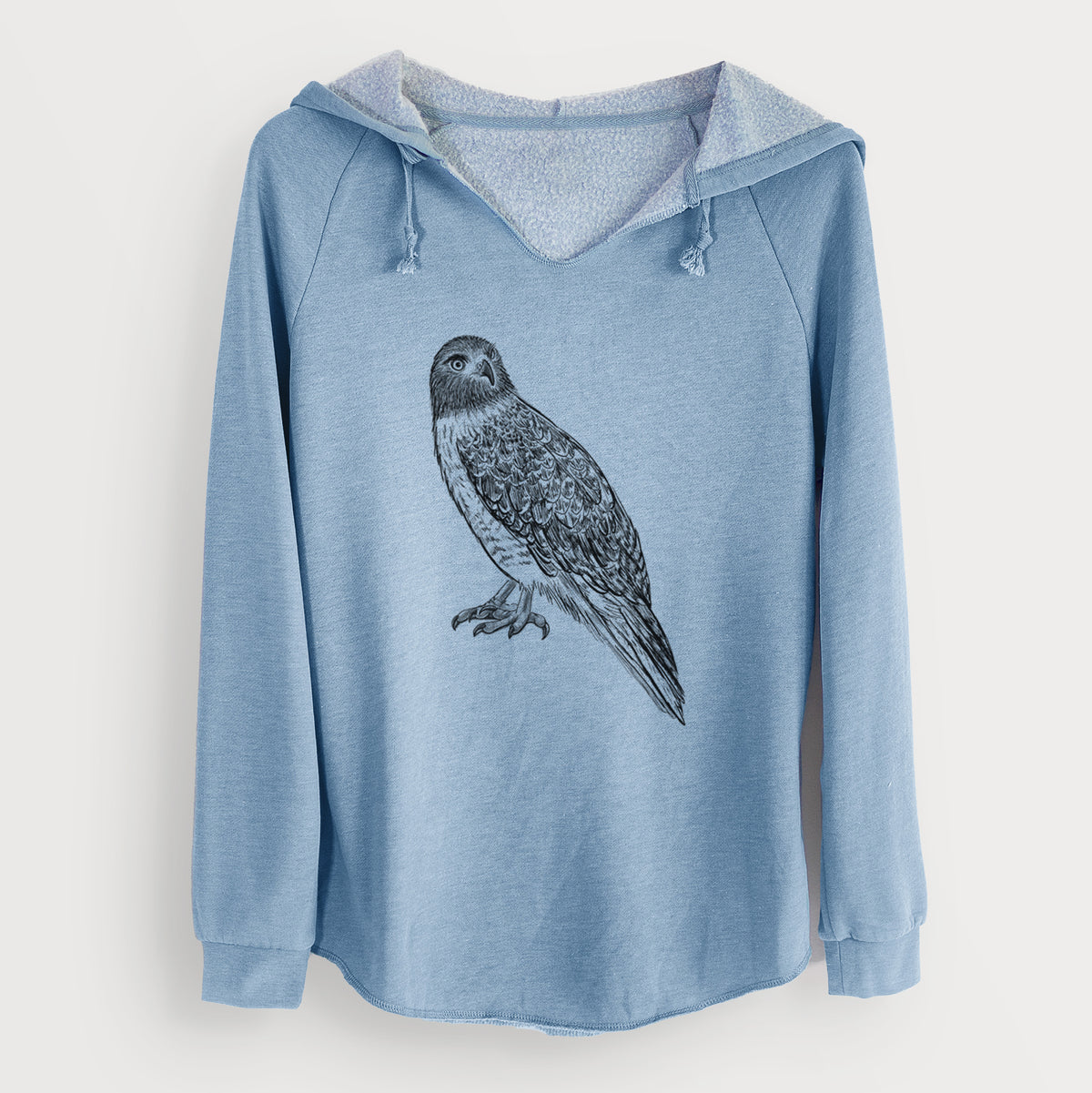 Misty blue women's Cali Wave hooded sweatshirt laid flat, printed with a detailed black ink illustration of a red-tailed hawk perched.